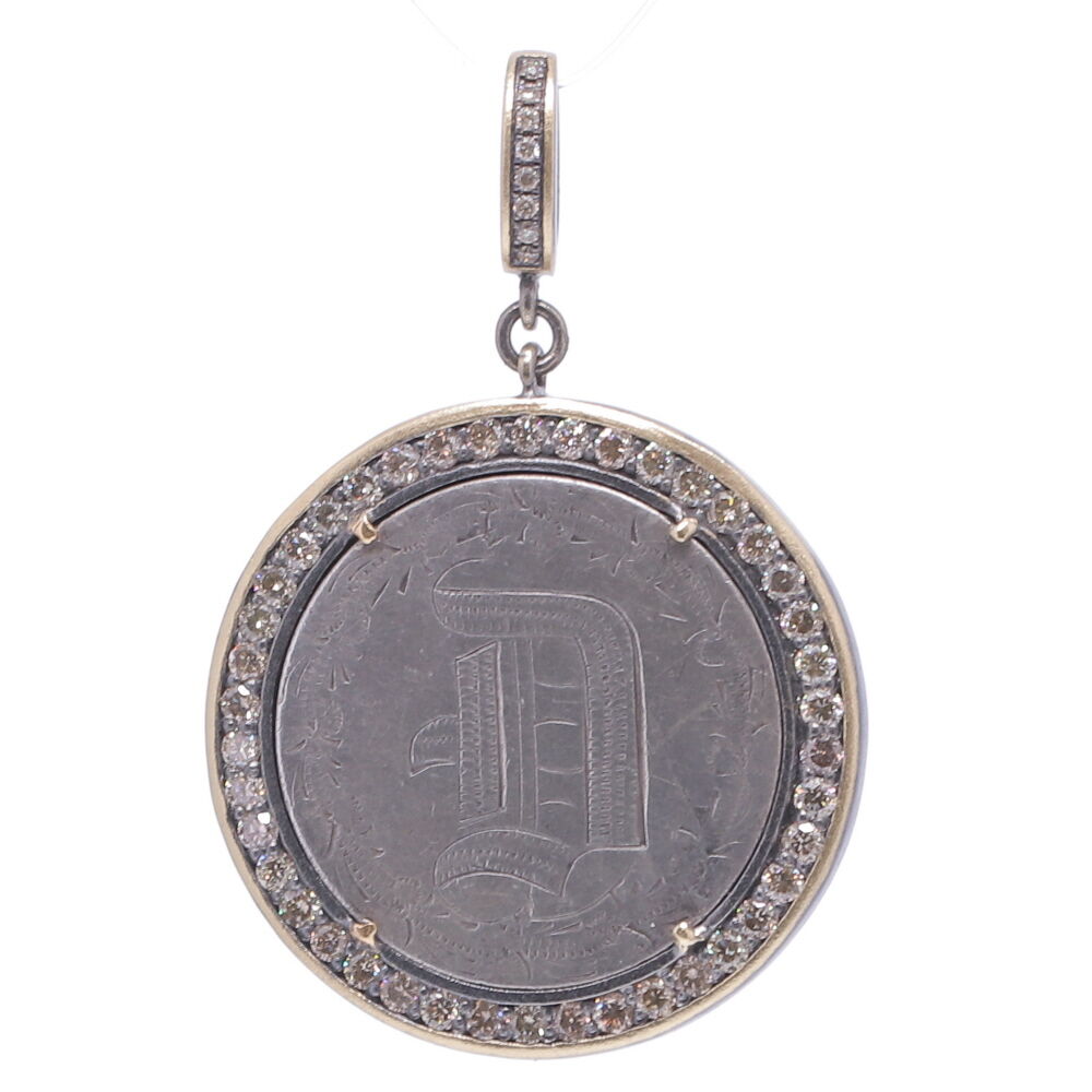 Love tokens reached their peak popularity during the Victorian era but are believed to have originated somewhere in Great Britain during the 1500’s. Often Love Tokens were exchanged between sweethearts as “tokens of love” or even marriage proposals. Love Tokens are generally defined as monetary coins from which one side (or sometimes both sides) have been smoothed down flat and engraved with names, phrases, monograms, and sometimes even pictorials.
This American Quarter with Engraved “D” was designed especially for you by Cynthia Ann. It is surrounded by a Champagne Diamond, 14k Yellow Gold and Black Rhodium Prong Set Bezel, Hanging from a 14K Yellow Gold, Black Rhodium and Champagne Diamond Openable Bale. Love Token Engraved With "D"