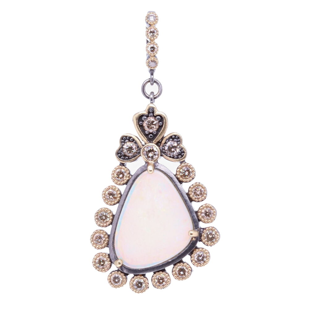 This Cynthia Ann classically styled dot bezel is framing this asymmetrical opal. The bezel has 1.28 TCW Diamonds, 14k Yellow gold 6.82g, and Rhodium Sterling Silver. The bale has a 4mm opening, allowing you to clip the pendant on different necklaces. Asymmetrical Opal Pendant