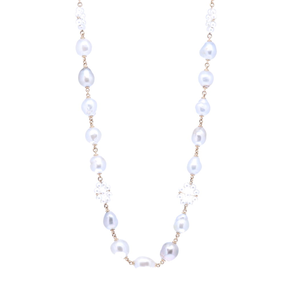 This Limited Edition baroque Tahitian pearl necklace is strung with 31, 10 mm mirror like pearls which are defined by their non-spherical shape. The pearls have a beautiful blue and gray hue. 14k Yellow Gold is strung in between each pearl, Akoya Pearl flower stations are displayed throughout the necklace. It's complete with a diamond clasp that opens up to 7mm. The total gold weight is 20.17g, and Diamond 0.27 tcw. Limited Edition Tahitian Pearl Necklace 29"