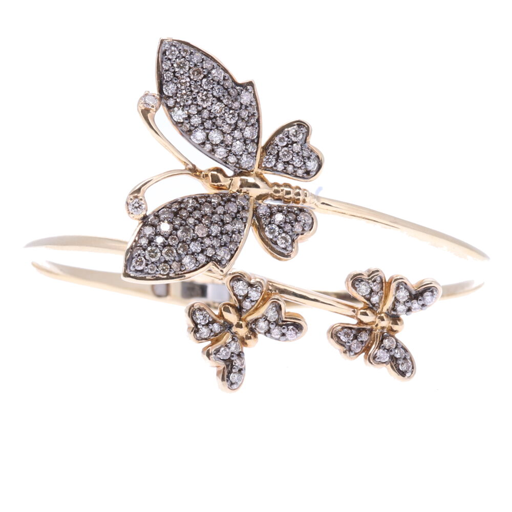 The butterfly is the symbol of resurrection and eternal life because they metamorphose from a caterpillar to a chrysalis and finally becomes a butterfly. Many believe that the soul left the body in the form of a butterfly. Aristotle named the butterfly 'psyche' which is the Greek word for Soul. This bracelet has a hinge opening constructed of 14k yellow gold 16.96g, rhodium sterling and Champagne diamonds 2.33 tcw. Size 7. Butterfly Hinged Cuff Bracelet