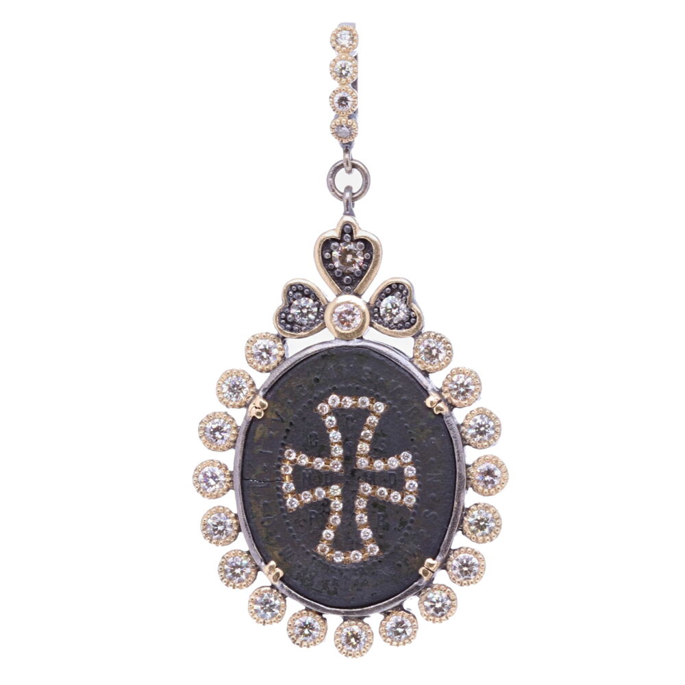 This ancient St. Benedict medal was set in a unique Cynthia Ann diamond bezel. The brown patina is original, it occurred from oxidizing over time. The large CSPB on the front stands for "The Cross of our Holy Father Benedict". Jesus's monogram "IHS" is on the top of the shield. V R S N S M V - S M Q L I V B on the front translates to "Begone Satan! Never tempt me with your vanities! What you offer me is evil. Drink the poison yourself! The diamond cross was inlayed, and the bezel consists of 1.65 TCW Diamonds, 14k Yellow Gold 7.2g, and rhodium sterling silver. This pendant can be clipped onto any favorite necklace. Ancient St. Benedict Pendant