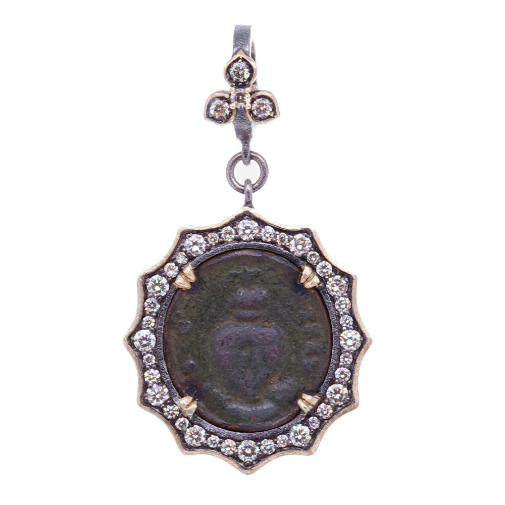 The Sacred Heart is often depicted in Christian art as a flaming heart shining with divine light, pierced by the lance-wound, encircled by the crown of thorns, surmounted by a cross, and bleeding. This ancient sacred heart medal depicts the Sacred Heart on the front and back. The medal is set inside a decorative diamond bezel 0.82 tcw, 14k Yellow Gold 2g and rhodium sterling silver bezel. The bale has a 4mm opening, allowing you to clip on multiple necklaces. Ancient Sacred Heart Pendant