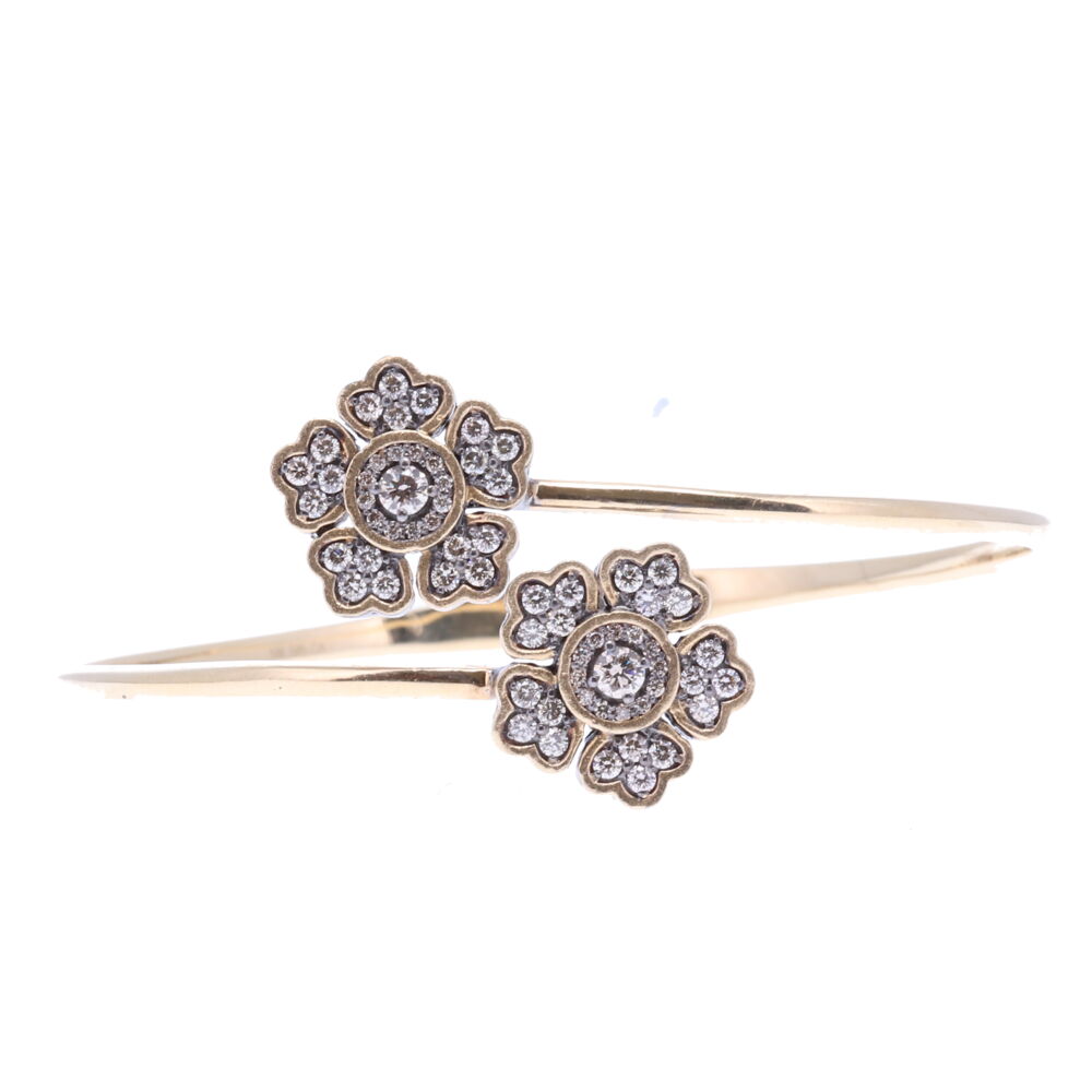 This floral hinged cuff bracelet is constructed of 14k yellow gold 8.77g, champagne diamonds 2.00, and rhodium sterling silver. Floral Hinged Cuff Bracelet