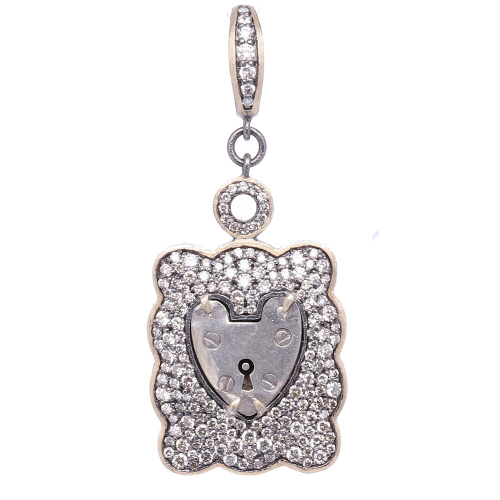 The Antique English padlock was typically worn on a bracelet and given to a loved one to show how much they were loved. Before going off to war, gentlemen would leave the bracelet locked around his loved one’s wrist and he would hold the key until his return. The heart shaped padlock was fashionable in the Victorian and Edwardian periods.
Small Vintage English London Padlock, Surrounded by a Champagne Diamond, 14k Yellow Gold and Black Rhodium Wide Pave Scalloped Bezel, Hanging from a Champage Diamond, 14k Gold and Black Rhodium Openable Bale.
173 Champagne Diamonds - 1.80tcw
14k Gold - 3.32g
Black Rhodium Silver London Framed Vintage Padlock