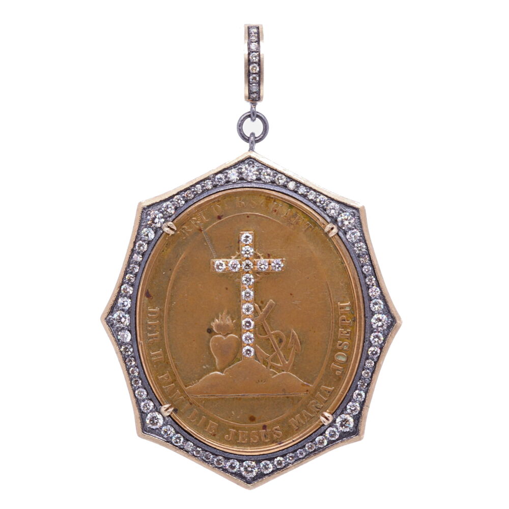 This German medal has Mary's Miraculous heart and a Mariner's cross. The Mariner's Cross is shaped like an anchor, it symbolizes a 'Fresh Start' or 'Hope'. Mary's Immaculate Heart represents her maternal love. The phrase on this German medal translates to "Family of Jesus, Mary, and Joseph". The back translates to "Family protector of our Congregation". This metal has diamond inlay on the front. It's set in a unique diamond bezel. Containing 14k Yellow Gold 3.64g, 1.4 carats of diamond, and rhodium sterling silver. the bale has a 4mm opening German Family of Jesus, Mary, and Joseph Pendant