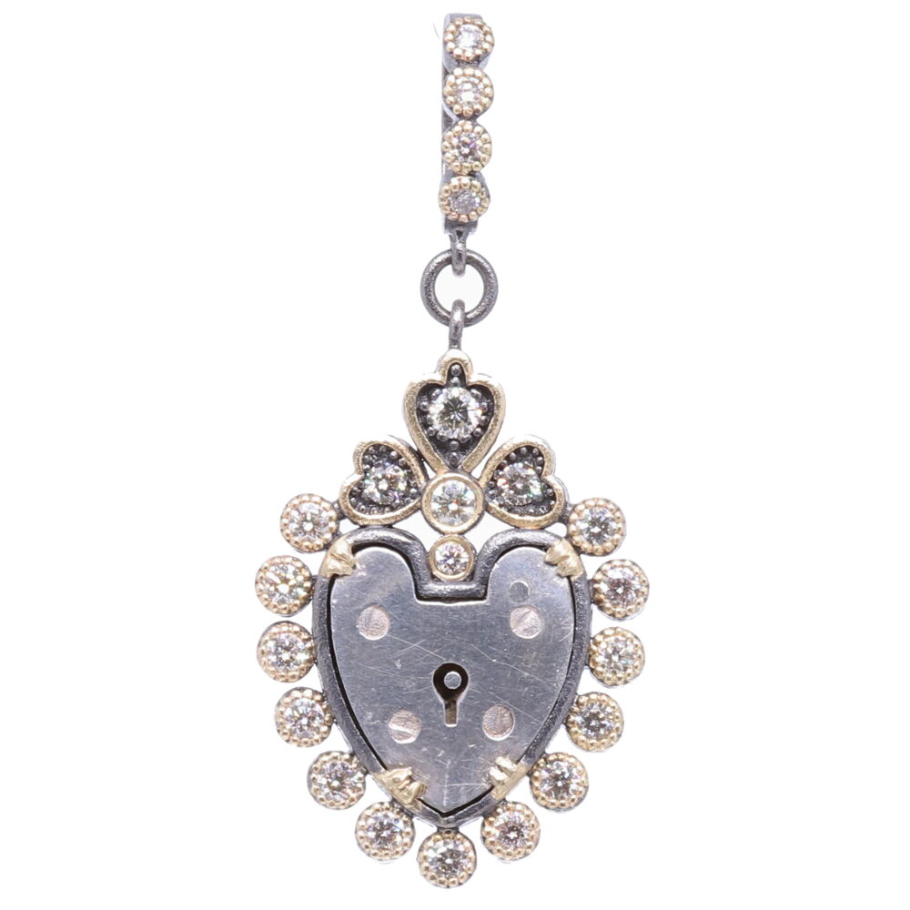 The English padlock was typically worn on a bracelet to show how much they were loved. Before going off to war, it was common gentlemen would leave the bracelet locked around his loved one’s wrist and he would hold the key until his return. The heart shaped padlock was fashionable in the Victorian and Edwardian periods. This pendants interior is an original English Heart Padlock. The padlock has a decorative dot bezel frame containing, 0.80 TCW Diamonds, 4.79g 14k Yellow Gold, and rhodium sterling silver. Antique English Padlock Heart Pendant