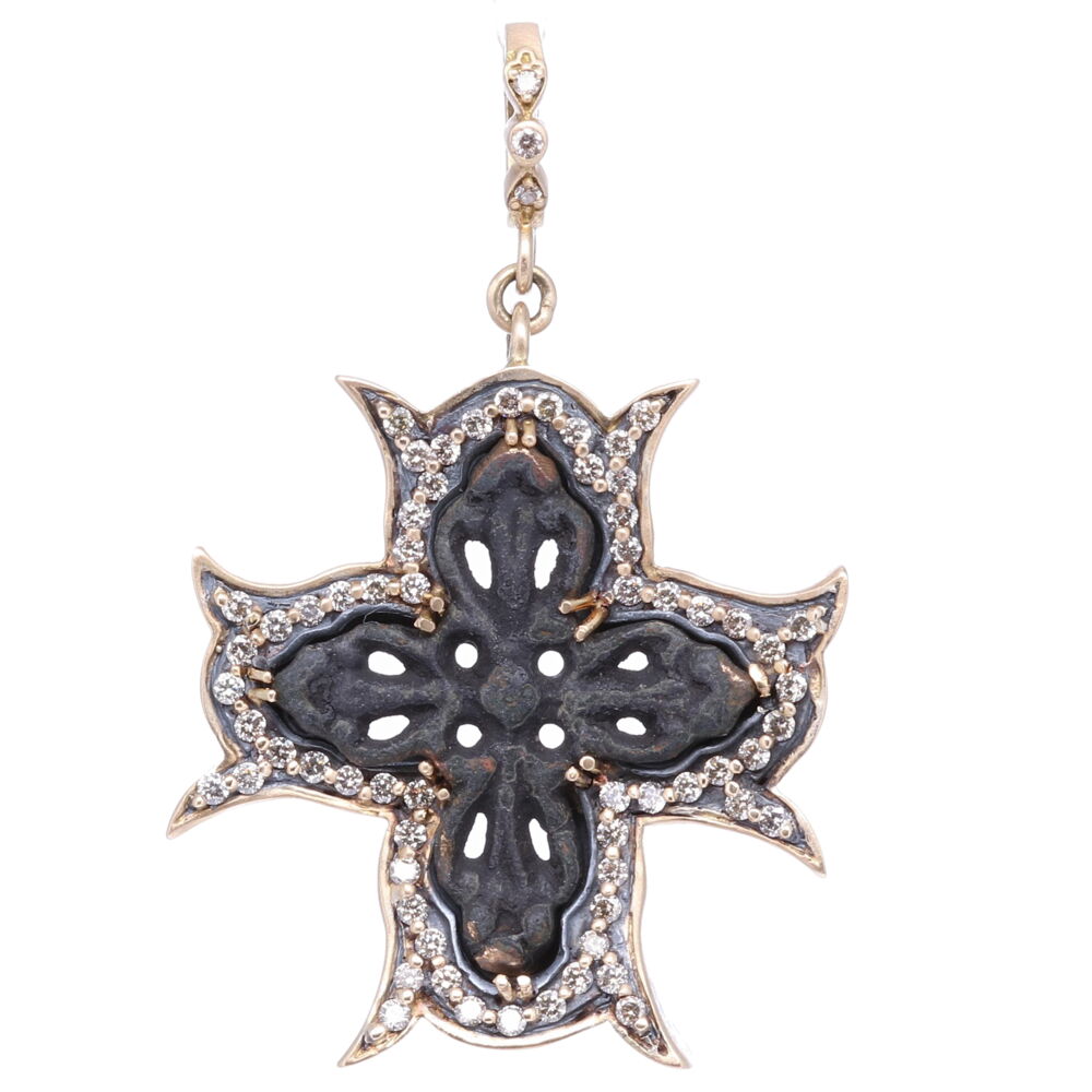 Religious medals with a crucifix, and their symbolic power, have been a galvanizing form for expressing one’s religious beliefs. The practice of wearing crosses, and religious medals with crosses, dates back to the early church. To modern Christians, the cross is an icon, a visual symbol of victory of Jesus over sin and death. This artifact cross has a natural green patina that has oxidized over time. It is set in a 14k Yellow Gold, Diamond 1.53 tcw, and Rhodium Sterling bezel. The bale opens to 4mm. Intricate Artifact Cross Pendant