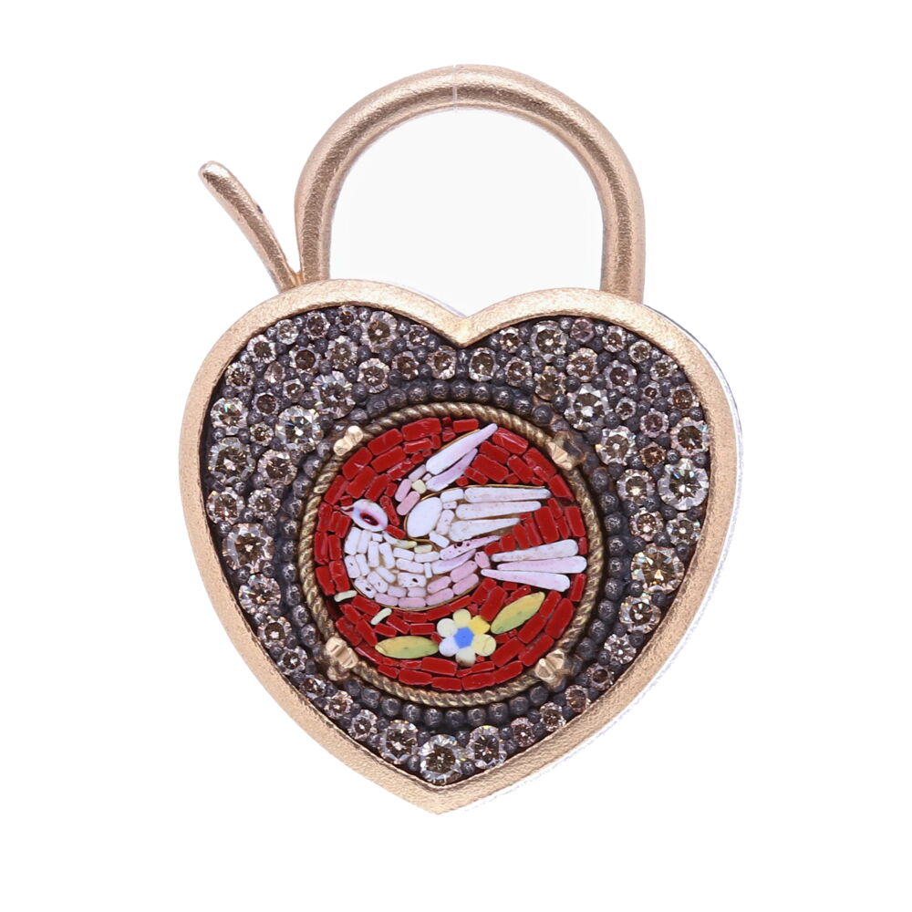 This original Italian micro mosaic was handcrafted in the 19c. The mosaic is set in an unique Heart Locket bezel with an open-able bale. The deep maroon color emphasizes the white dove facing left. Doves symbolize the Holy Spirit and send us important messages from the Divine. A dove is a reminder that there is always hope and peace if you seek it. The bezel is 14k Yellow Gold, rhodium sterling, and Diamond 1.00 tcw. This locket can be worn as a pendant or as a charm on a bracelet. Red Italian Micro Mosaic Holy Spirit Dove Heart Locket Pendant/Charm