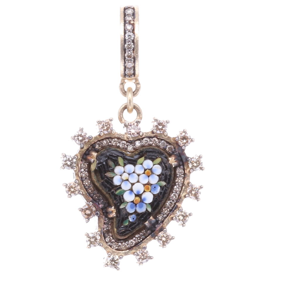 Wearing a heart symbolizes your declaration of love, compassion, and healing. Hearts are used as a protection from evil. This original 19c Italian micro mosaic heart is enclosed with a unique diamond bezel. The mosaic flowers are a beautiful robin's egg blue color and the black mosaics make the flowers pop! The heart is swooping to the left. Folk tales say when a heart is swooped to one side it is absorbing only good energies. This mosaic is set in a 14k yellow gold 4.96g, rhodium sterling, and diamond 1.08 tcw bezel. Black Antique Italian Micro Mosaic Heart Pendant with White Flowers
