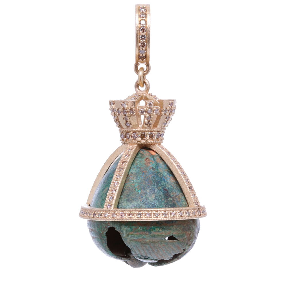 This Ancient Bell found in Ukraine, dates back to 9-10 AD. The Natives believed that noise making with a bell kept evil spirits away. The bell would have been attached to a bronze chain and worn as a brooch, necklace or headdress accessory. This bell is hollowed out on the inside, the clapper makes musical notes when struck. The bell has an original green patina from oxidizing over time. This bell has been set in a handmade solid 14k yellow gold 7.8g and diamond 0.86 tcw bezel. Antique Bronze Church Bell with a Crown Pendant
