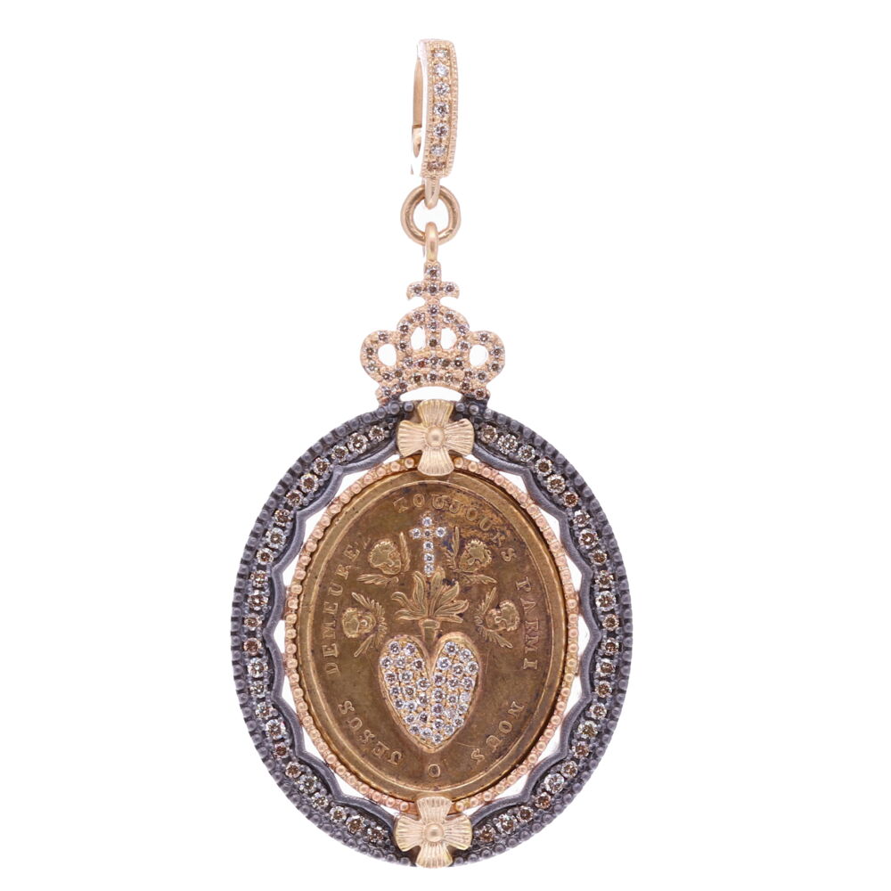 This very rare Sacred Heart medal depicts Cherubs surrounding Jesus's heart, displaying his love for all of humanity. The front translates to "Jesus lives among us" and the back "Christ have mercy on us". When times are tough the Sacred Heart brings the most peaceful moments to families and individuals because of the unconditional love that it symbolizes. Sacred Heart with Cherubs Pendant