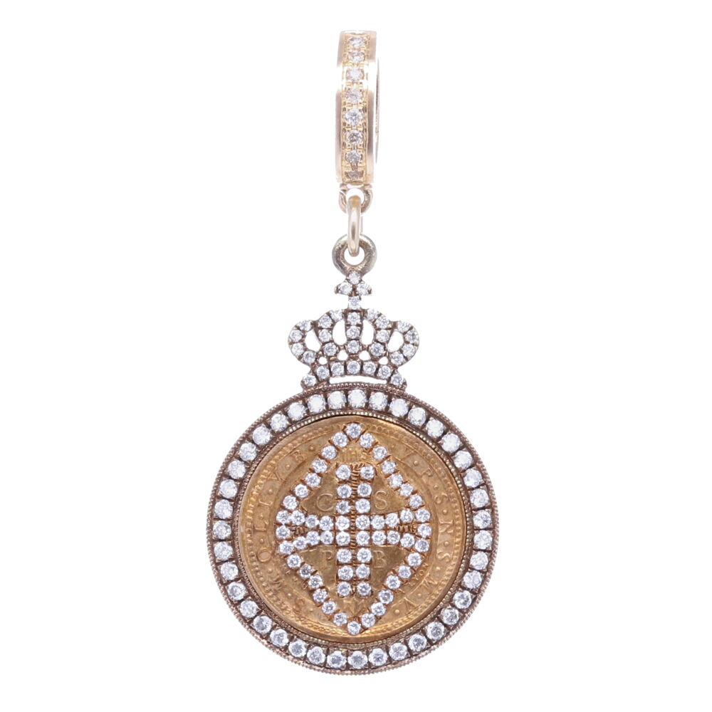 This small sized St. Benedict medal is the size of a dime. The top of the medal displays IHS or Jesus's monogram. The large CSPB stands for "The Cross of Holy Father Benedict". Cynthia Ann created a diamond inlay shield around the CSPB. The exterior of the medal V R S N S M V - S M Q L I V B on the front translates to "Begone Satan! Never tempt me with your vanities! What you offer me is evil. Drink the poison yourself!". This medal is set in a diamond 0.68 tcw and sterling silver bezel with a 14k yellow gold bale. Antique St. Benedict Pendant with Cross Shield Inlay