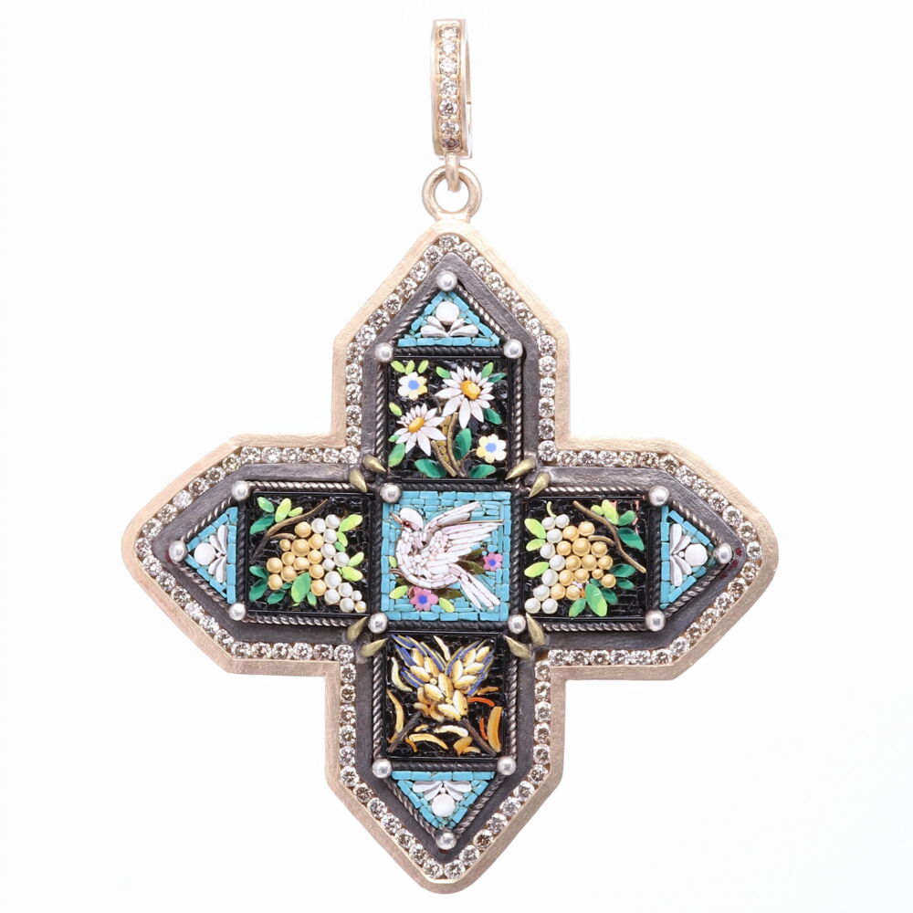 This one of a kind micromosaic maltese cross was handcrafted in Italy in the mid 19c. It's beautiful channel set diamond bezel was added by Cynthia Ann to enhance the beauty of this historic piece. The wheat is the symbol of charity and love. The grapes; prosperity and abundance. The Dove; the symbol of the Holy Spirit. The original cross is set in a 14k Yellow Gold 7.12g, Diamonds 1.552 tcw, and Rhodium sterling bezel. The bale opens to 4mm accommodating most substantial chains for such a stunning piece. Blue Antique Italian Micro Mosaic Cross Pendant with Dove, Wheat, Flower, and Grapes