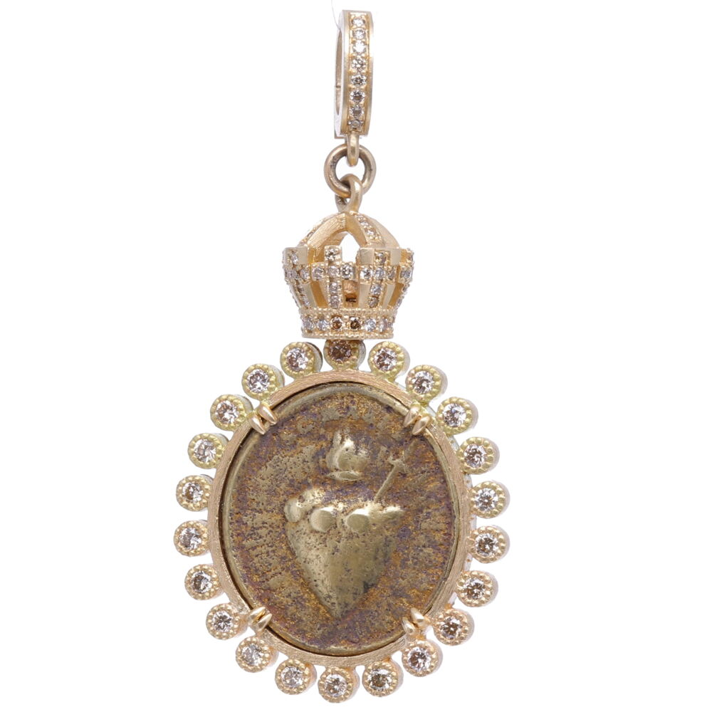 This antique Sacred Heart bronze medal has a beautiful depiction of Jesus's Heart representing his love for all humanity. The antiquity is set in a crown bezel handmade with solid 14k yellow gold 12.46g and diamond 1.30 tcw. Cynthia Ann designed a Crown bezel symbolizing the reward in heaven (the crown) coming after the trials in this life (the cross). The front of the medal pictures the Sacred Heart as a flaming heart pierced with a lance-wound. On the back, the heart is surmounted with a Cross. Antique Sacred Heart with Crown Pendant