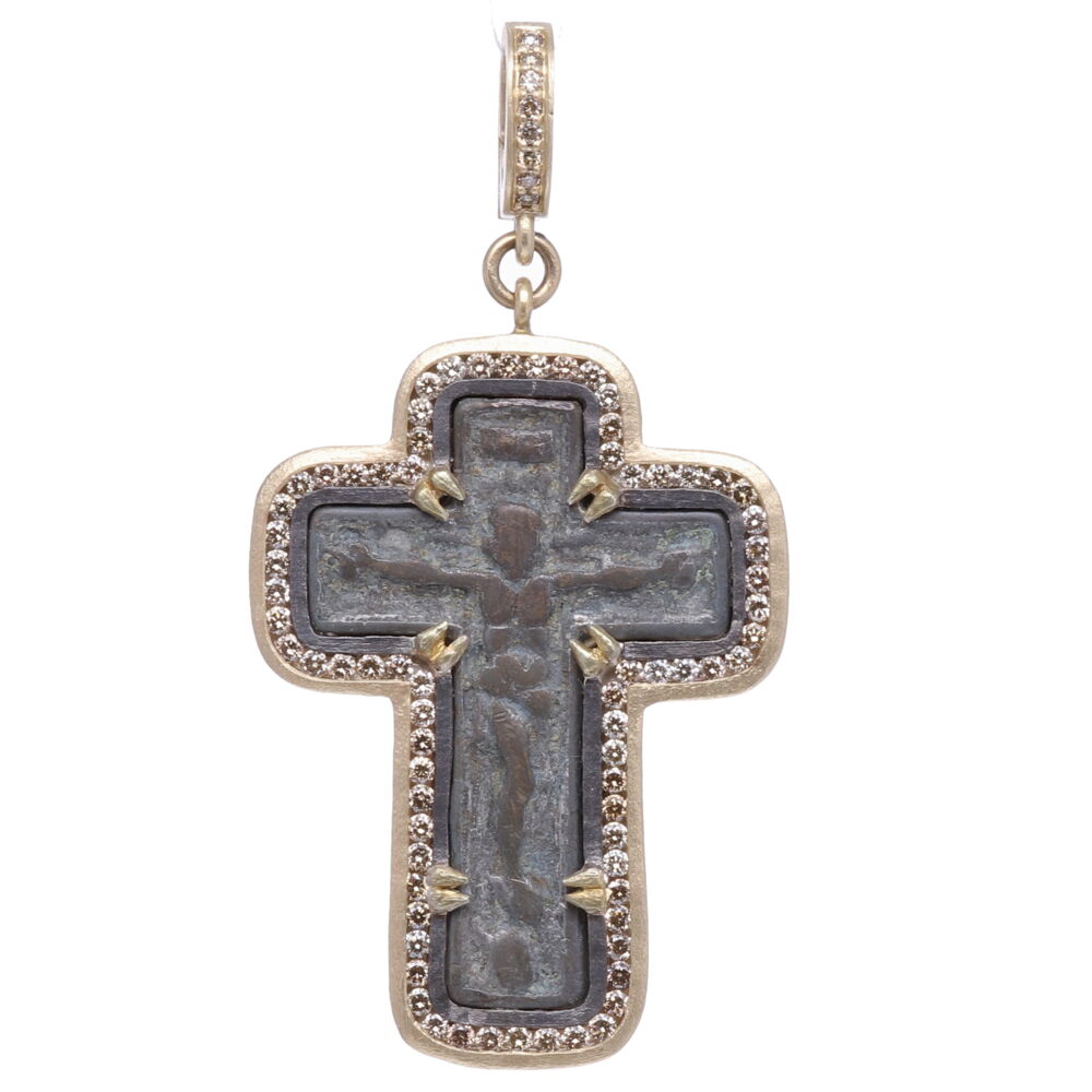 The Old Believers Crucifix is defined by it’s straight lines and no curves. The Orthodox “Old Believers” were an Orthodox sect that broke from the official Russian Orthodox Church as a protest against church reforms; the schism took place in the 17th century. This original Old Believers Crucifix was handcrafted using the "Lost Wax method". Cynthia Ann set this one of a kind antiquity in a 14k yellow gold 4.94g and channel set diamond 1.16tcw bezel. The crucifix has a bale that opens up to 4mm. Ancient Old Believers Crucifix Pendant