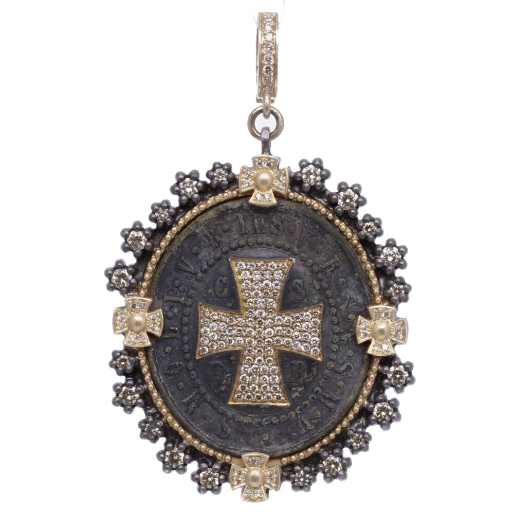St. Benedict medals provide the ultimate protection from evil. This Latin antiquity has "CSPB" on the front of the medal representing the monogram for "The Cross of Holy Father Benedict". Cynthia Ann inlayed a diamond shield and used champagne diamond 1.69 tcw, 14k yellow gold 1.75g, and rhodium sterling to set this antiquity. The medal has an original green patina that occurred from oxidizing overtime. The St. Benedict medal is one of the oldest and most honored medals used by Christians. Around the shield is a Latin monogram "IHS" Jesus. The monogram letters "V R S N S M V - S M Q L I V B translate to "Begone Satan! Never tempt me with your vanities! What you offer me is evil. Drink the poison yourself! St. Benedict Diamond Shield Pendant