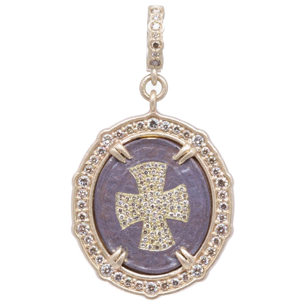 Carrying a St. Benedict medal provides you with the highest protection from Evil. The top of the medal displays IHS or Jesus's monogram. The large CSPB stands for "The Cross of Holy Father Benedict". Cynthia Ann created a diamond inlay shield inside the CSPB. The exterior of the medal V R S N S M V - S M Q L I V B on the front translates to "Begone Satan! Never tempt me with your vanities! What you offer me is evil. Drink the poison yourself!". This medal is set in a diamond 1.20 tcw, rhodium sterling, and 14k yellow gold 9.85g bale. St. Benedict with Diamond Cross Shield Pendant