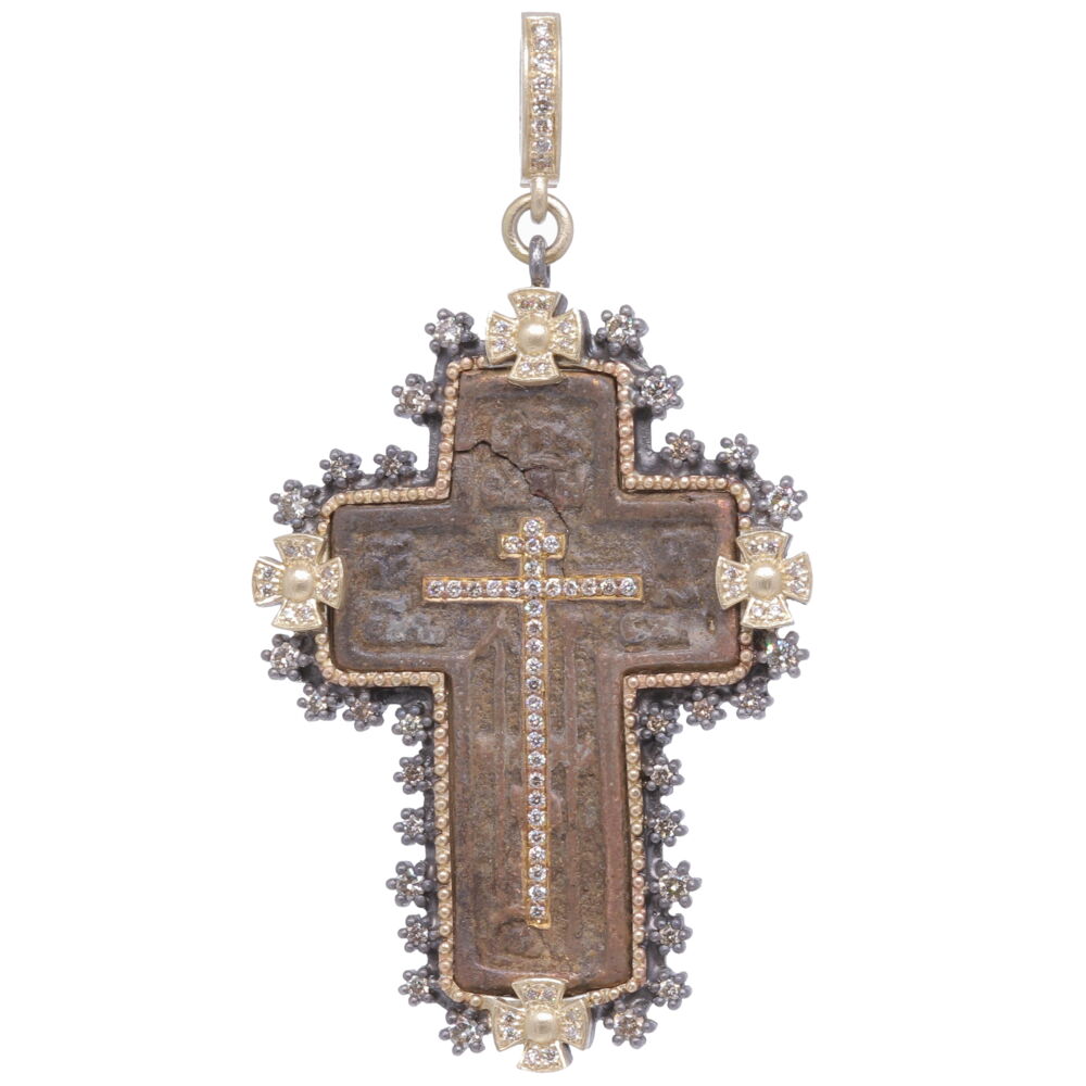 The Old Believers Cross is defined by it's strait lines and delicate designs. The original antiquity was set in a Cynthia Ann 14k yellow gold 9.47g, rhodium sterling, and champagne diamond 1.00 tcw bezel. The Old Believers were a protestant sect that broke away from the Russian Orthodox Church in the 17th Century. Cynthia Ann enhanced this cross with a diamond cross inlay, the original brown patina is authentic. Old Believers Cross Pendant