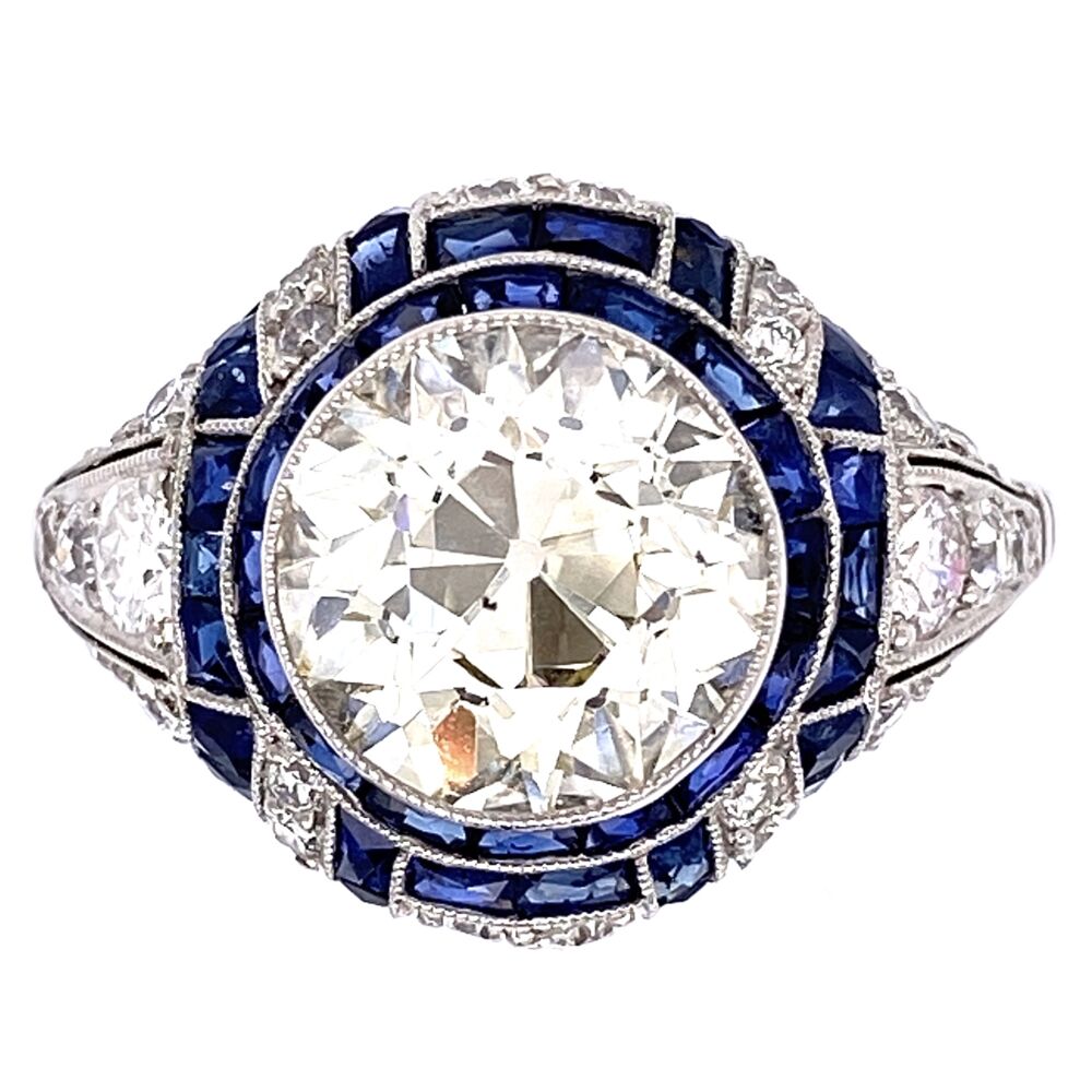 Platinum Art Deco ring with old european cut diamond surrounded by side diamonds and French cut sapphires. 2.90 OEC diamond center is L, si2 (100% Eye Clean). Size 6.75.
https://youtu.be/fRflKpmZddA Platinum Art Deco 2.90 OEC Diamonds surrounded by .75tcw side diamonds and French cut sapphires