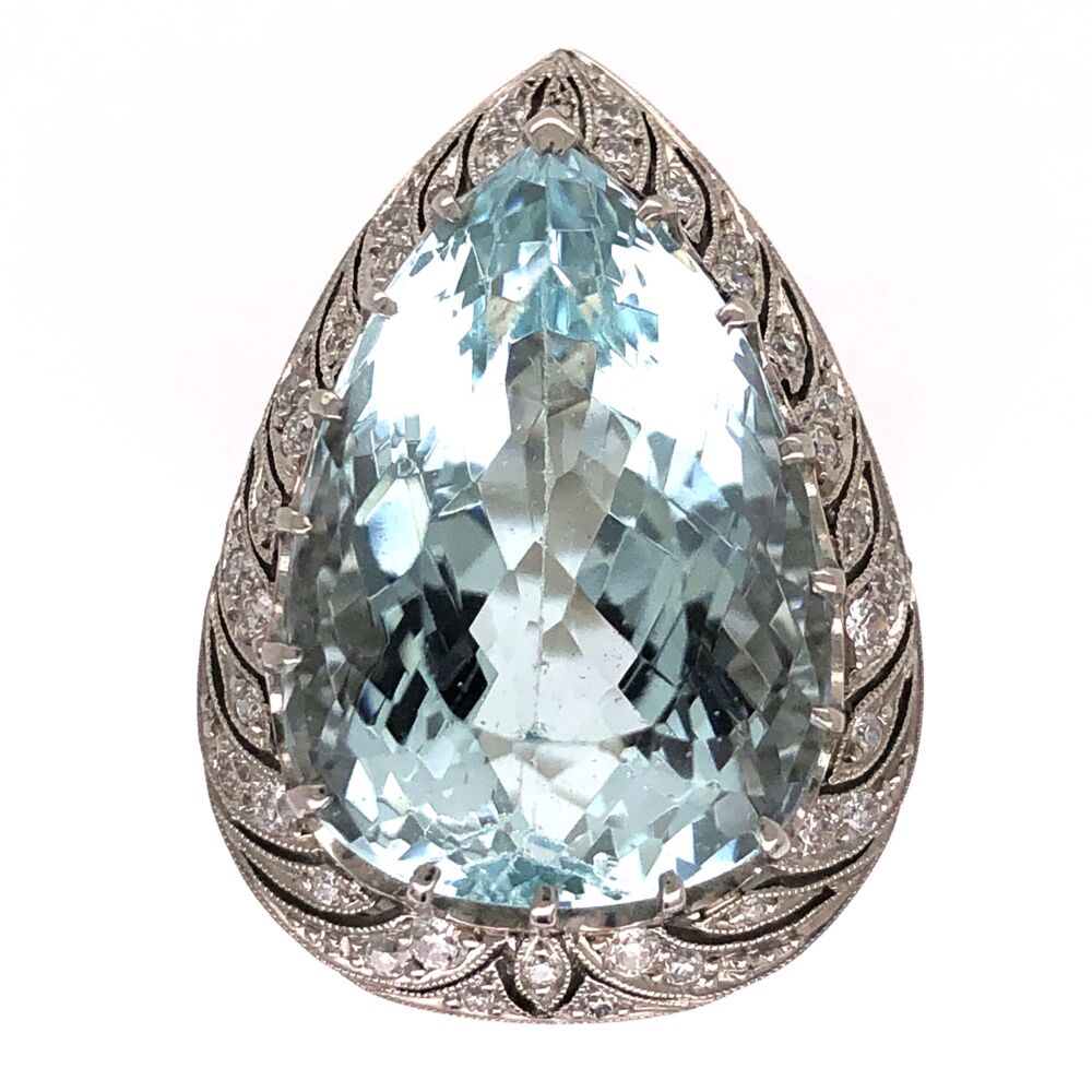This alluringly vintage platinum ring, is from the Art Deco era. A pear cut, this 17.80 carat Aquamarine shines surrounded by a halo of white diamonds, with a total weight of .60 carats. The beautiful light greenish blue of Aquamarine is reminiscent of sea water, from where it derived its name. Aquamarine's name is of Latin origin: aqua (for water) and marina (for the sea). This ring is perfect for a night out, make a statement wherever you go. Platinum Art Deco Pear Shape Aquamarine Ring