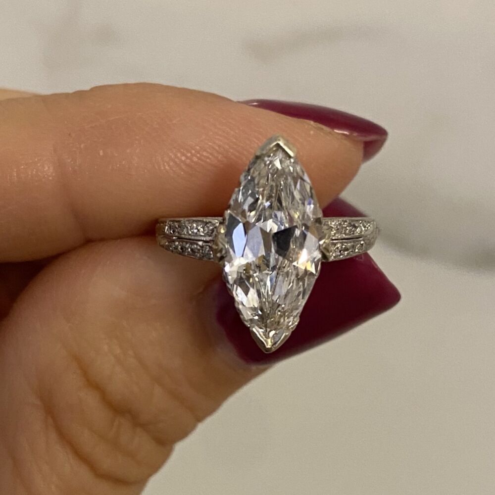 <p><a href="https://youtu.be/qdmcw625BBE" title="undefined" style="text-decoration: none;">YouTube</a></p><p>This rare, high color natural Diamond in it's original cut from the 1800's has the same amazing brilliance it's had for the last 200 years! This ring is petite yet bold, set in stunning platinum, perfectly embodies the cutting edge motifs of the Art Deco era.</p>
<p>Diamond accents and milgrain decorate the gallery and sculpted shoulders while a shimmering Antique Marquis cut diamond rests at the center (approx. 0.51 total carat weight). </p>
<p>The center 2.38ct Marquis is accompanied by a GIA lab report that can be found using this certification #6204872085.</p> High Color Platinum Art Deco 2.38ct Antique Marquis Ring GIA D Color