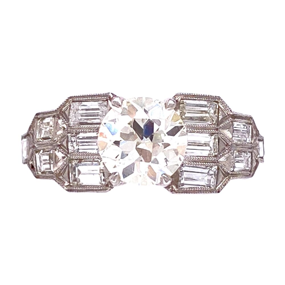 This ring is a super cool Art Deco engagement ring with side baguette diamonds, engraving & milgrain that go half way down the shank! The center is an Old European Cut round brilliant diamond that weighs 1.15ct. Platinum Art Deco 1.15ct OEC Diamond Ring with Baguette sides 5.0g