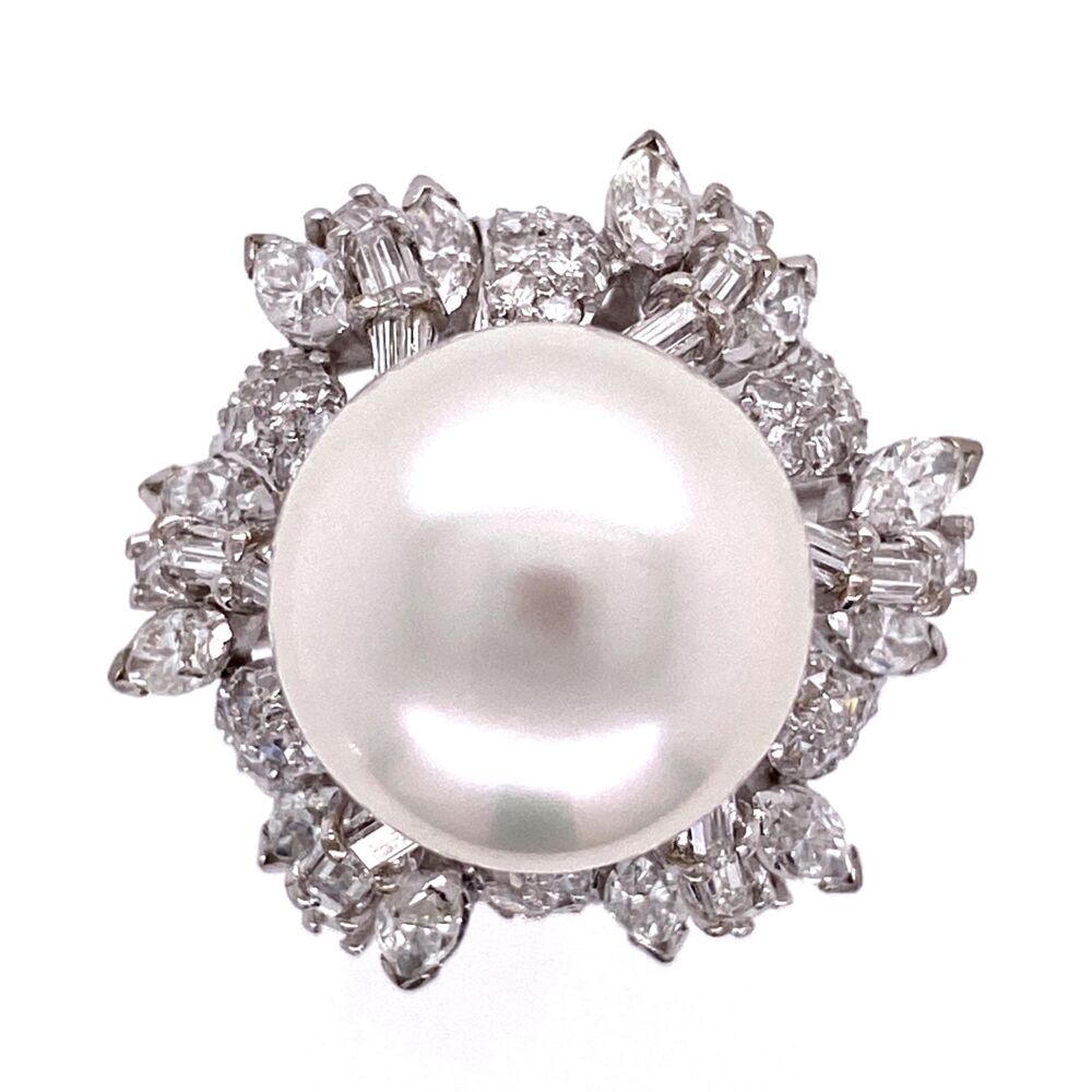 This ring has a beautiful, white south sea cultured pearl with almost no blemishes and have approx. 2.45tcw diamonds cascading down as an apron above the finger. There are marquise, straight baguettes and round single cut diamonds all white and clean 18K WG 12mm South Sea Pearl & 2.45tcw Diamond Ring 12.7g, s