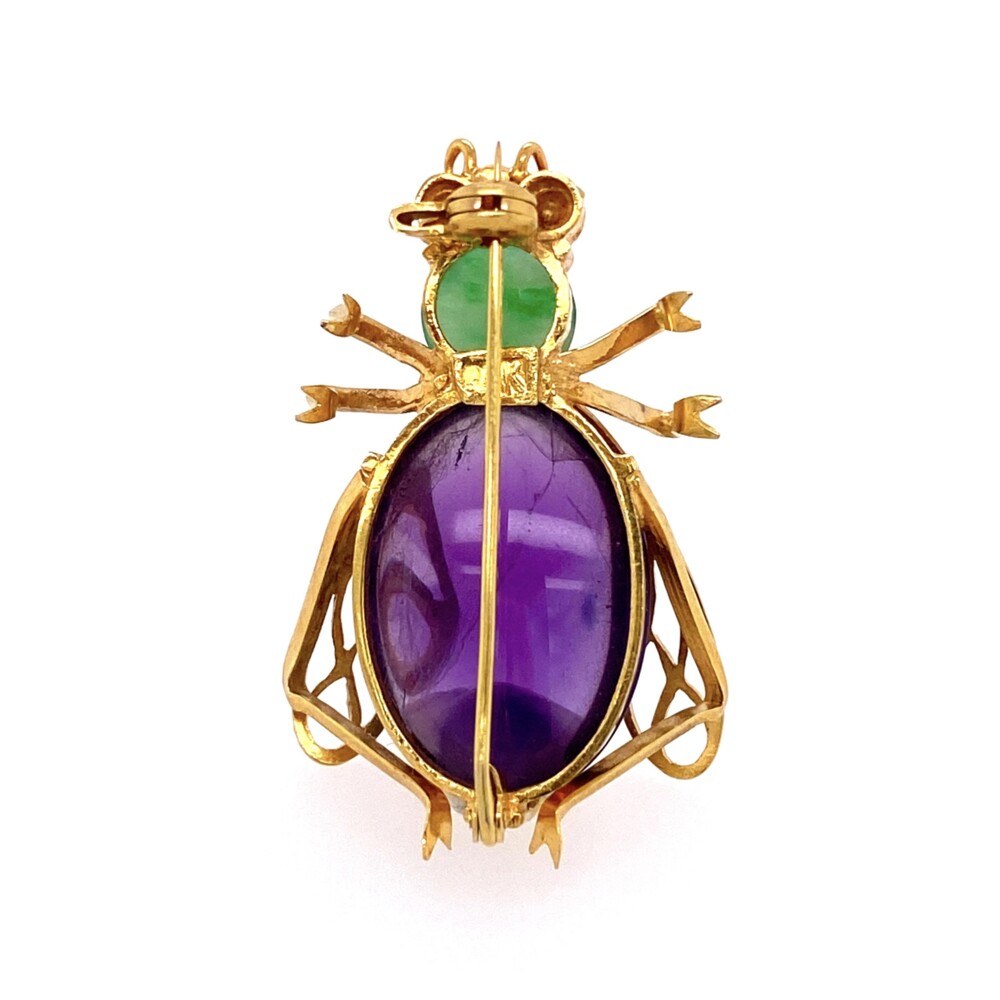 One oval cabochon amethyst is about 12.00ct, one cabochon jade about .80ct & two round ruby eyes are approx. .14tcw bring together this cool bug brooch. Is it a horse fly? A beetle? Bee?<div style="position: initial; margin: initial;"><span style="font-size: 16.8px; position: initial; margin: initial;"><a href="https://youtu.be/jyRWaptrA2k" title="https://youtu.be/jyRWaptrA2k" style="text-decoration: none;">https://youtu.be/jyRWaptrA2k</a></span><br style="position: initial; margin: initial;"></div> 14K YG 1960's Bug Brooch with Amethyst, Jade & Rubies