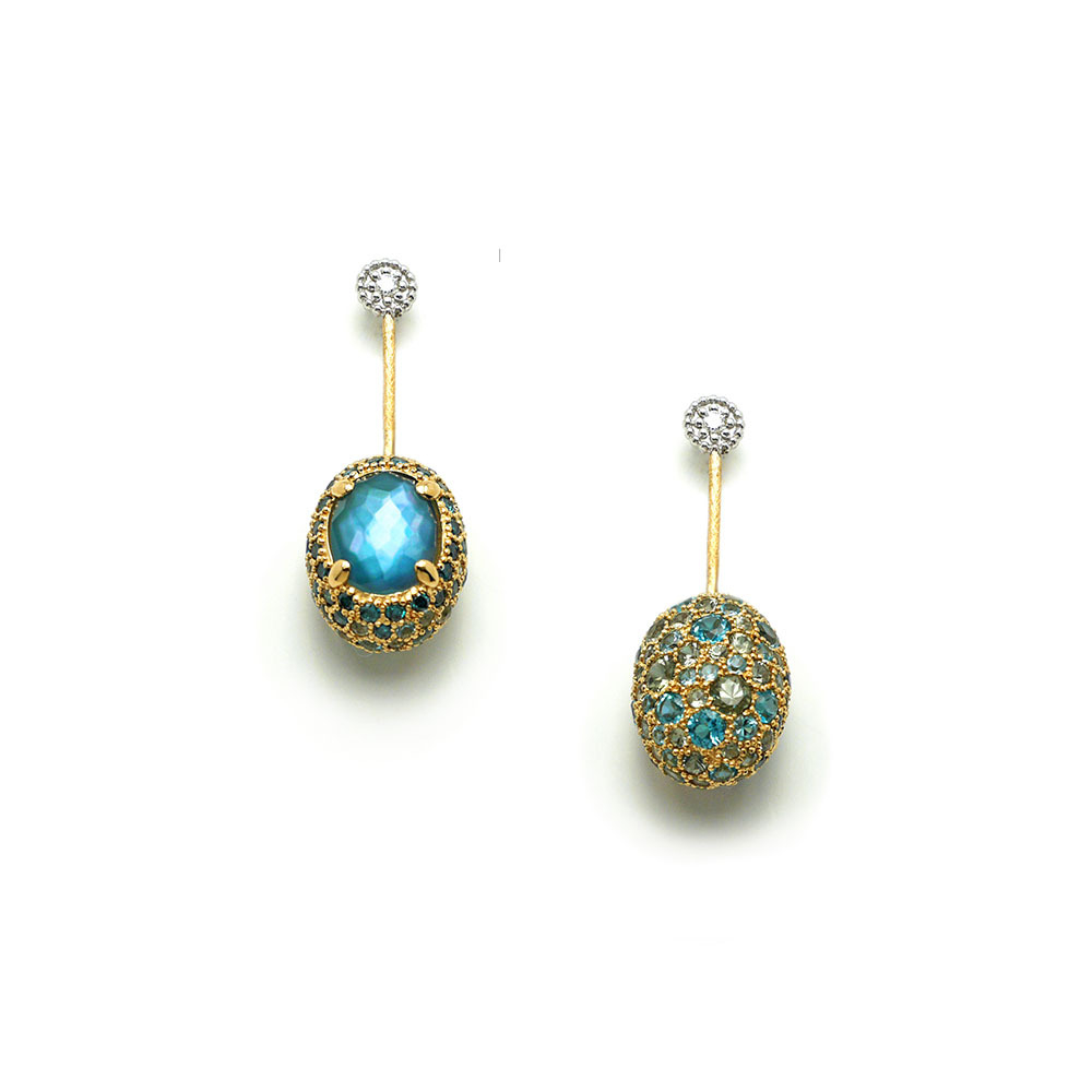 These wondrously dazzling 18K yellow gold drop earrings brought to you by Nanis Fine Jewelry and Italian designer Laura Bicego bring grace and grandeur. They feature an oval bead at the bottom set with large London blue topaz on one size and pave topaz, sapphire and diamond on the other. They can be worn with either the large topaz or the pave facing out. Dancing In The Rain Reverso Drop Earrings