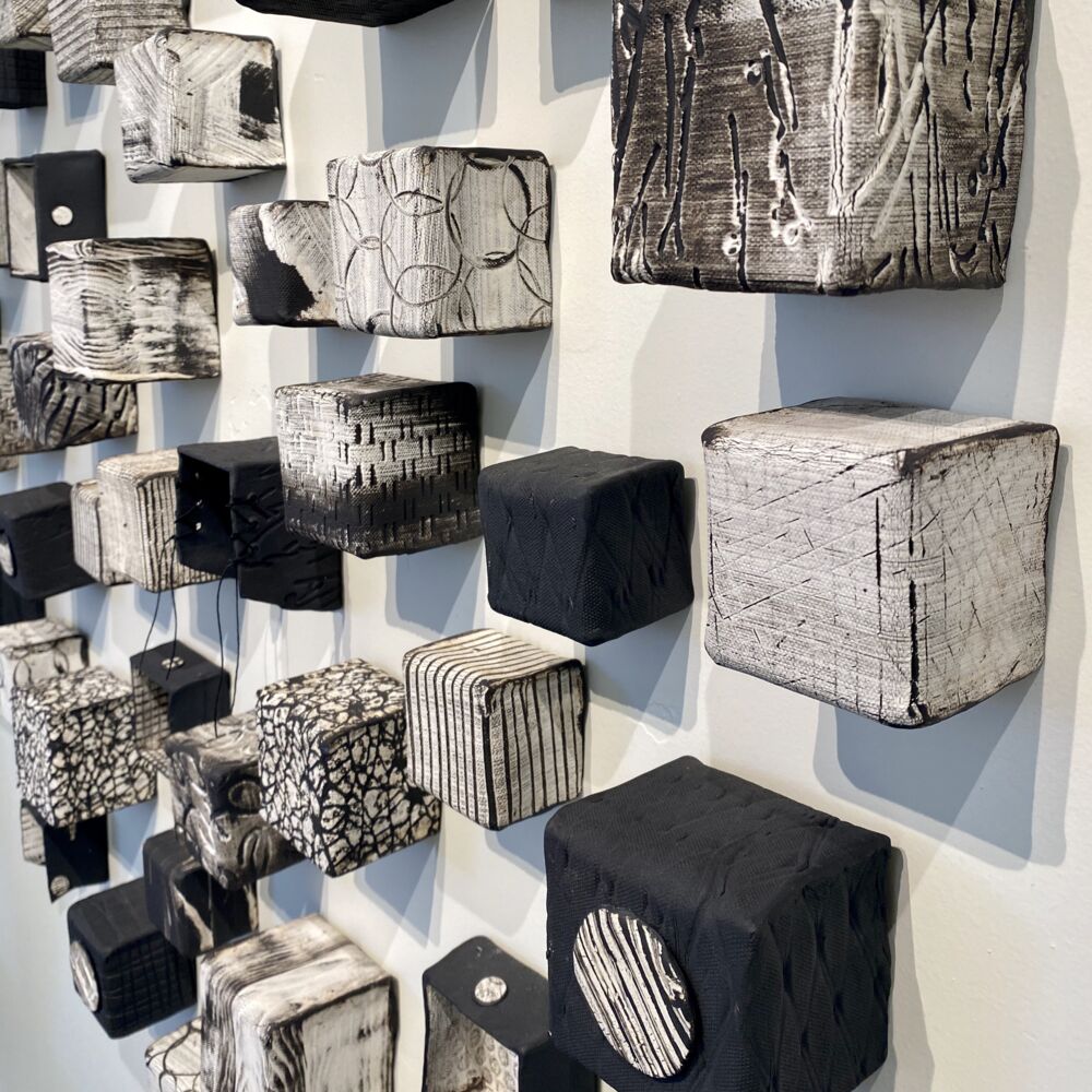 This beautiful ceramic wall sculpture by Jodi Walsh was created through a process called oritatami nendo, or folding clay. Inspired by nature, Cubes (Small) recreates the intimate connection we all feel to nature. Cubes Small