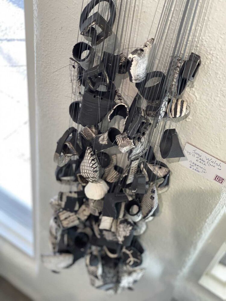 This thought-provoking wall art by Jodi Walsh was created through a process called oritatami nendo, or folding clay. Inspired by nature and featuring several ceramic pieces on string, I'll Take One of Each recreates the intimate connection we all feel to nature. I'll Take One Of Each