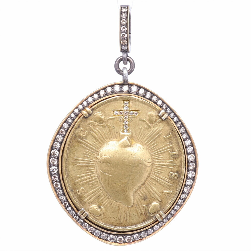 This original antique brass Sacred Heart medal is set in a 14k Yellow Gold 1.38g, Diamond 0.81 tcw, and Rhodium Sterling bezel. The front has a diamond cross emphasizing the Sacred Heart and four cherubs surrounding the divine light. The back displays Mary and Child. The bale opens to 4mm. The Sacred Heart is often depicted in Christian art as a flaming heart shining with divine light, pierced by the lance-wound, encircled by the crown of thorns, surmounted by a cross, and bleeding. Brass Sacred Heart with Cherubs Pendant