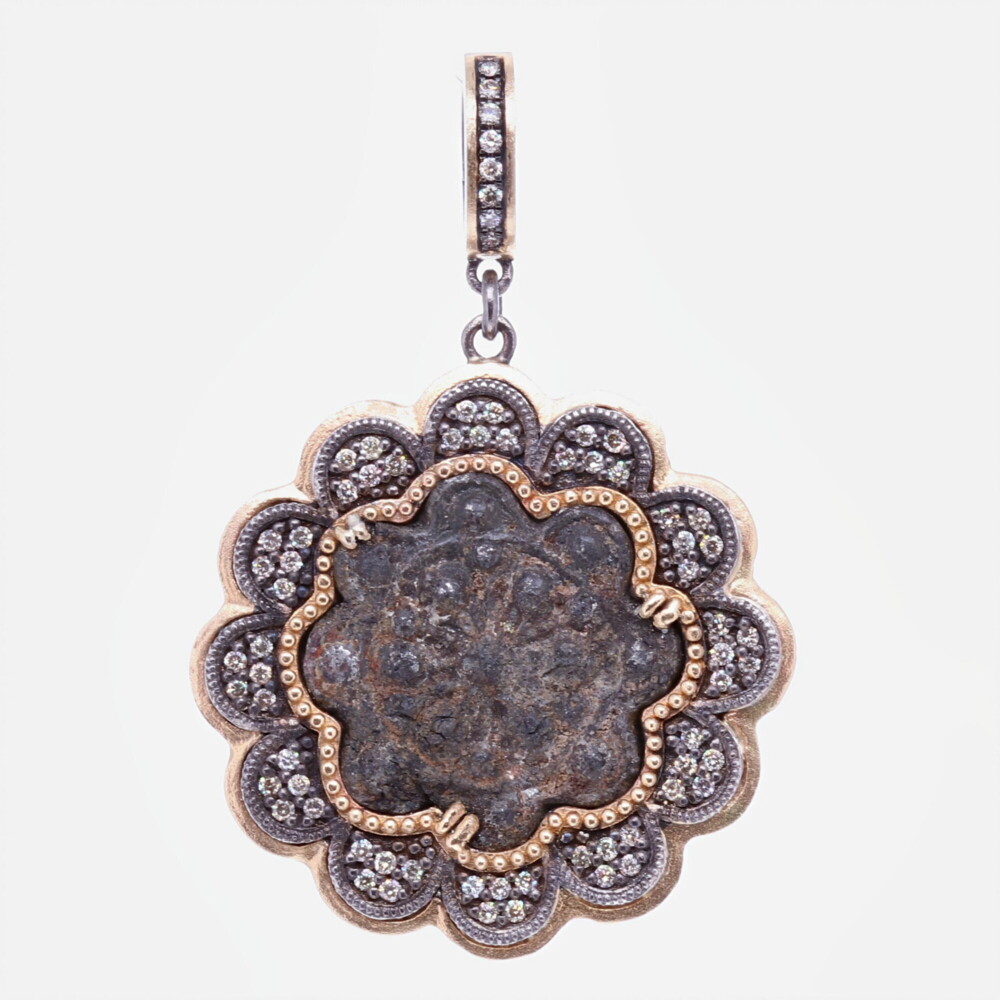 This 15-16th Century flower shaped artifact is original. It's framed by a unique scalloped bezel to mimic the artifact. The bezel has 0.45 carats of Diamond and 5.37g 14k Yellow Gold and rhodium sterling silver. The bale has a 4mm opening so it can be clipped onto different necklaces. 15-16th C. Flower shaped Artifact Pendant