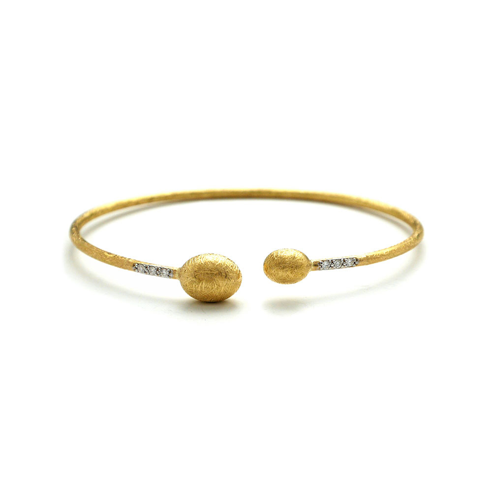 This beautifully bold 18K yellow gold bangle bracelet brought to you by Nanis Fine Jewelry and Italian designer Laura Bicego brings sheer luxury. It features an open wire design with smaller gold oval beads at the ends and 0.08 carat white diamonds set into the wire at the top. Dancing In The Rain Small Bead Gold Wrap Bangle Bracelet