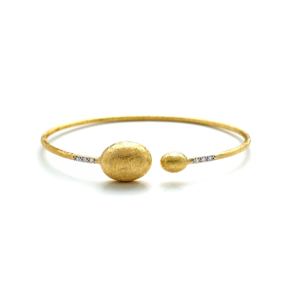 This beautifully bold 18K yellow gold bangle bracelet brought to you by Nanis Fine Jewelry and Italian designer Laura Bicego brings sheer luxury. It features an open wire design with larger gold oval beads at the ends and 0.06 carat white diamonds set into the wire at the top. Dancing In The Rain Large Bead Gold Wrap Bangle Bracelet