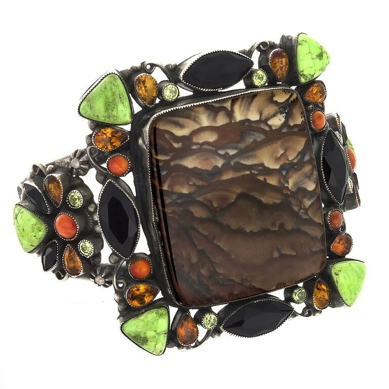 A truly beautiful Jasper Cuff . A large center stone of Picture Jasper is surrounded by faceted Peridot, Garnet and Citrine. Cabochons of Spiny Oyster and Lime Green Turquoise also make this Picture Jasper Cuff glisten with overwhelming beauty. Leo Feeney Picture Jasper Cuff -Clouds With Onyx, Green Turquoise, Citrine, Peridot & Spiny Oyster
