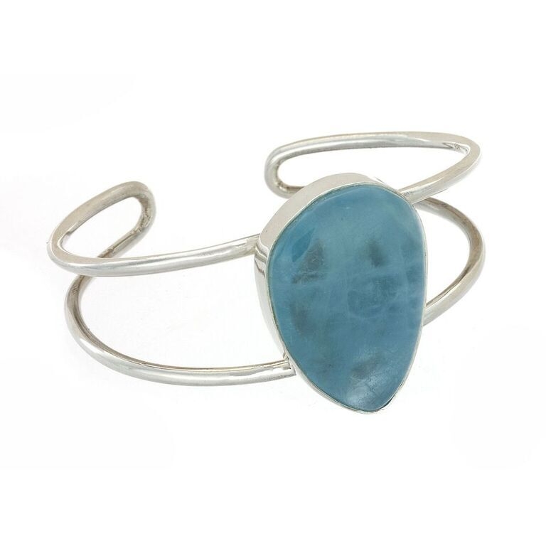 <font size="4">This Aquamarine cabochon cuff is a bright jewel. The gemstone is polished in a free-form shape, making it a one-of-a-kind versatile jewelry piece. Set in sterling silver, simple and stunning it </font>evokes<font size="4"> a happy smile upon all faces that it encounters.</font> Aquamarine Cuff - Single Simple Center