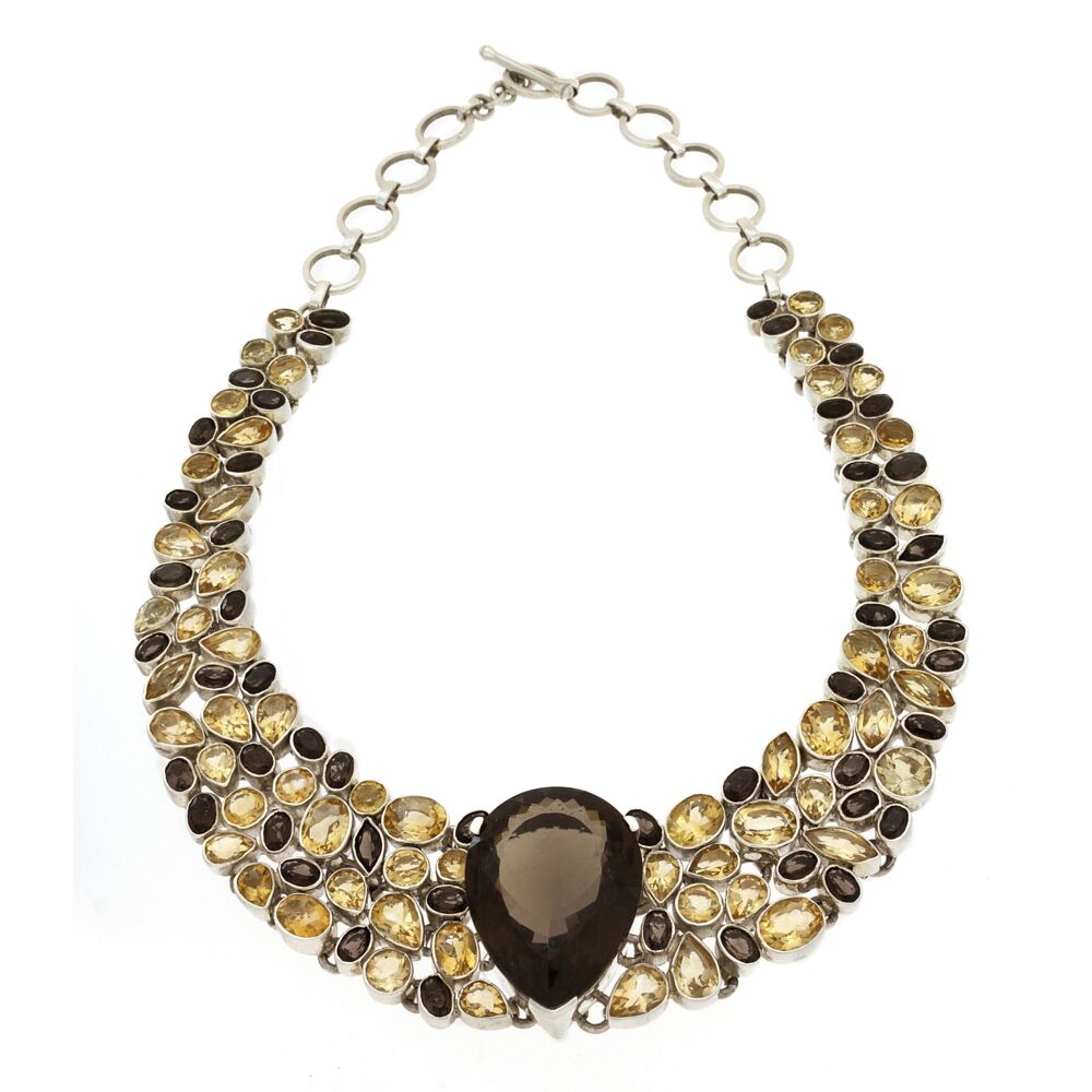 This bright Smokey Quartz and Citrine faceted demi-collar necklace is versitle and classy. All placed in a fluid sterling silver cagework setting with toggle clasp, it will rest comfortably and weightlessly on any neckline. Smoky Quartz & Citrine Necklace Collar