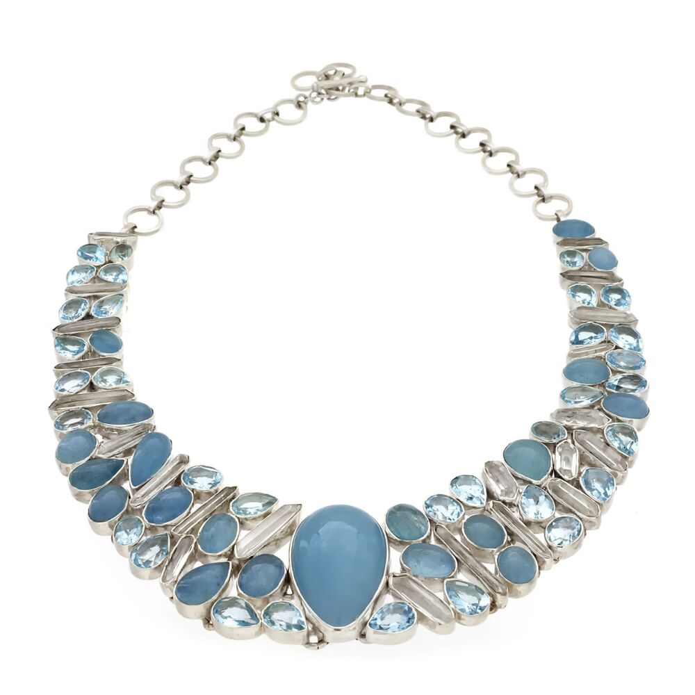 <font size="4">The color saturation of the exquisitely polished-to-perfection aquamarine center piece of this collar style necklace is astounding. The bright sparkle of the oval and pear shaped faceted blue topaz reflect off the double terminated quartz crystals and additional aquamarine cabochons throughout. Each incredible gem is bezeled and set in .925 sterling silver allowing the necklace to move and bend with comfort. Large round silver links and a toggle style closure. Feel like you just stepped into a fairy tale!</font> Aquamarine Necklace -Collar With Quartz Crystals & Blue Topaz