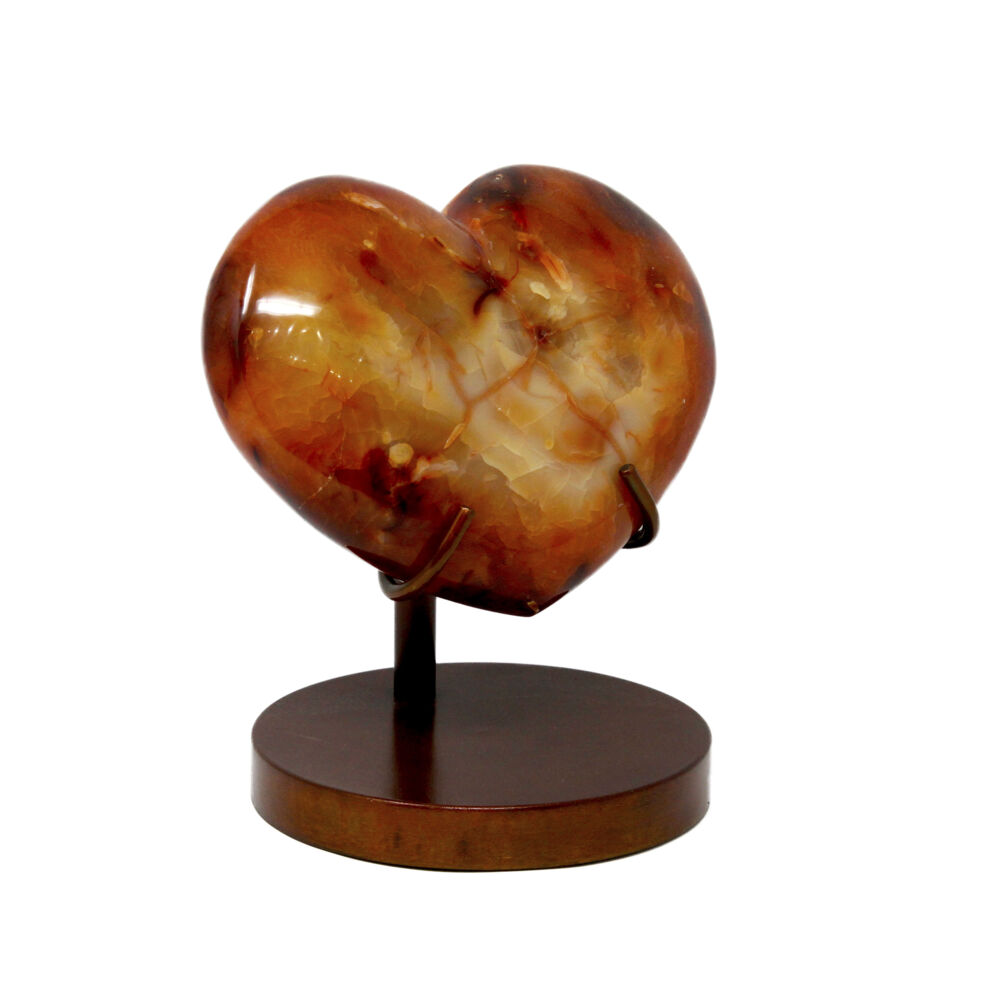 <span></span><span style="font-family: Arial;"><span style="font-family: Quicksand;"><font size="4">This polished carnelian heart is bold and rich in layers of swirling colors. Carnelian is a warm and vibrant stone that boasts confidence and the power of true expression. Carnelian is chalcedony that has been colored by the impurity of iron oxide. This semi-precious carnelian heart in a custom crafted prong-style stand with circular base makes a great gift for your loved ones or yourself.</font></span></span> Carnelian Heart In Custom Stand