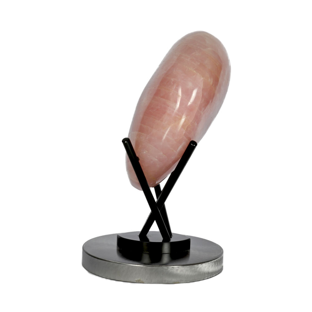 <span></span><span style="font-family: Arial;"><span style="font-family: Quicksand;"><font size="4">Soft petal-pink color draws the eye towards this polished rose quartz heart is cradled in the outriggers of this custom metal stand. The dark patina of the circular base stand, beautifully contrasts the intense pink hues of this massive polished rose quartz heart. The subtle white veining running through this gorgeous heart enhance the stunning pink color of this impressive rose quartz heart on custom metal stand.</font></span></span> Rose Quartz Heart On Custom Stand With Sharp Oval Base