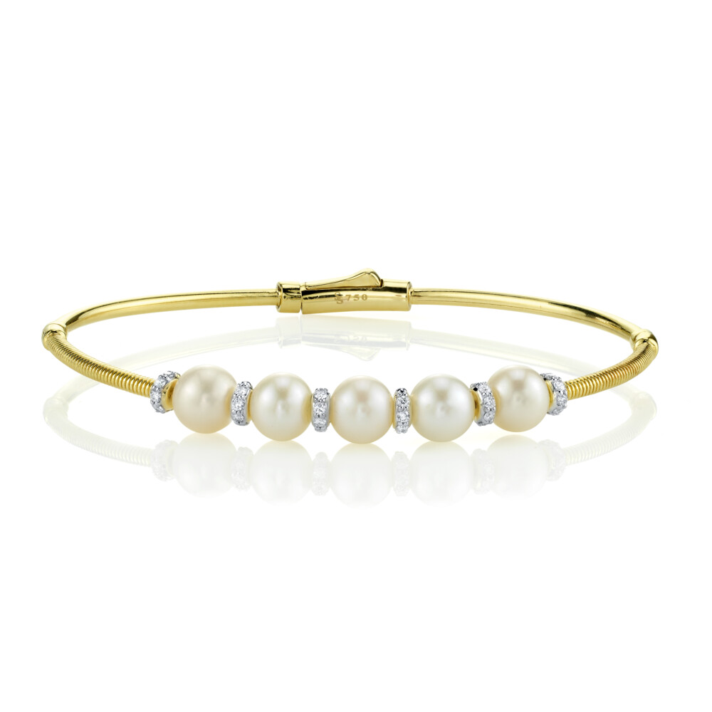 <span style="font-size: 16.8px; position: initial; margin: initial;">BEAUTIFUL AND EASY TO WEAR WHITE PEARL AND DIAMOND BANGLE BRACELET IN 18K YELLOW GOLD WITH FIVE LUSTROUS AKOYA PEARLS SEPARATED BY SHIMMERING PAVE DIAMOND ROUNDELS WITH STRIE DOUBLE HINGE WITH EASY TO CLOSE CLASP. WEAR EVERY DAY OR DRESS IT UP FOR A MORE FORMAL LOOK. </span> Pearl Station Bangle With Diamonds