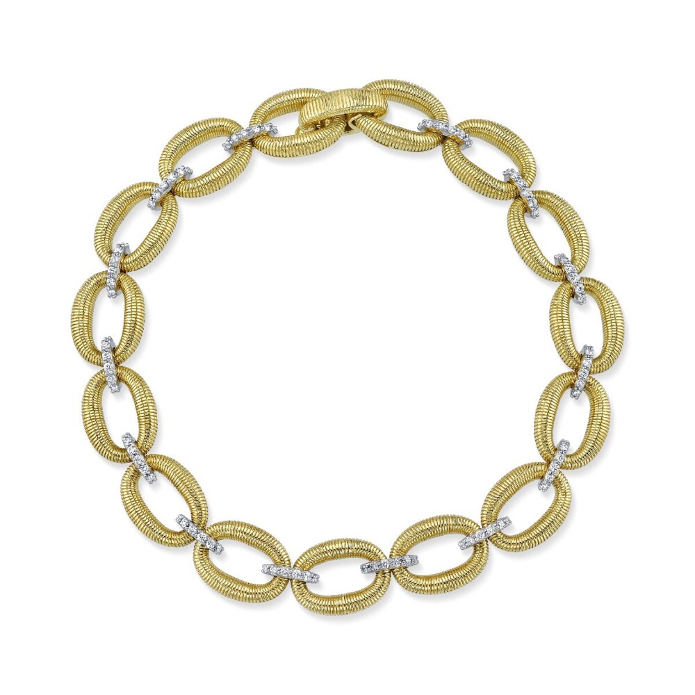 SLOANE STREET ICONIC SMALL OVAL LINK BRACELET IN 18K YELLOW GOLD FEATURES ROUNDED GOLD STRIE TEXTURED OVAL LINKS SEPARATED BRILLIANT WHITE DIAMOND STATIONS AND EASY-TO-USE HIDDEN CLASP. THIS MALLEABLE LINK BRACELET IS WEIGHTY WITH A BEAUTIFUL HAND YET CLASSICALLY FEMININE AND SURLY TO BE A STAPLE IN YOUR COLLECTION FOR YEARS TO COME. Strie Donut Link Bracelet With Diamonds