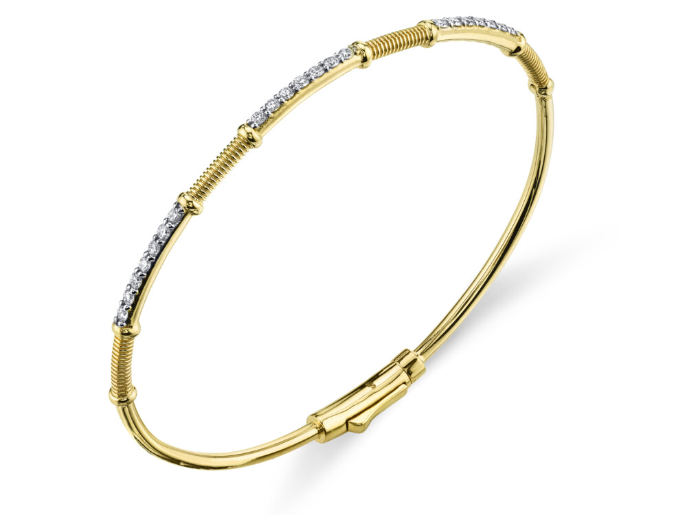 THIS DELICATE AND BRILLIANT SLOANE STREET PAVE WHITE DIAMOND BANGLE BRACELET IN 18K YELLOW GOLD IS THE PERFECT ADDITION TO ANY STACK. THREE SPARKLING ROWS OF WHITE DIAMONDS ARE BROKEN UP BY OUR SIGNATURE STRIE TEXTURED ACCENTS CREATING A UNIQUE TWIST ON A CLASSIC WITH DOUBLE HINGE AND HIDDEN LOCKING CLASP. Diamond And Strie Skinny Bangle