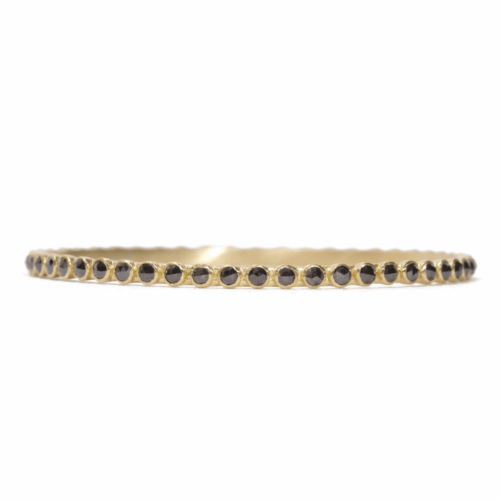 Sueno Collection brought to you by Armenta bring you this rose-cut black diamond eternity bangle. Displayed in an 18k yellow gold, this bracelet is perfect to stack. Black Diamond Eternity Bangle