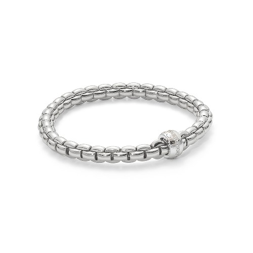 Eka – meaning ‘one’ in Sanskrit – is a whole new way of wearing gold bracelets. Based on one of Fope’s inventions from the 1950s, it applies the concept of flexibility to jewelry, blending together luxury and innovation. With its classic gold mesh design reworked in ultra-contemporary style, Flex’it has proved an instant global success. The effortless simplicity of every Fope bracelet ensures that you don't have to sacrifice your comfort for fashion. Classic yet fashion forward, this is most certainly not your grandmothers jewelry, each piece of FOPE gives an aura of intelligence and sophistication to those who wear it. Each bracelet has over 100 tiny 18k gold coils set into the interior of the link that allows the bracelet to expand and contract, rolling perfectly onto your wrist with ease. Handcrafted in Italy entirely from 18k gold and diamonds, this Eka Flex'it bracelet in size medium features one diamond rondel 0.18 cts of VS F/G Diamonds. FOPE Flex'It Bracelets are made in Five Sizes - Extra Small(15cm.), Small(16cm.), Medium(17cm), Large(18cm), and Extra Large(19cm). Standard size is considered medium and does fit most people. There are price differences between each size so please reach out to us for pricing information. Size/Color available for immediate shipment: 1. Size medium bracelet in yellow gold with a white gold diamond rondel 2. Size medium bracelet in white gold with a white gold diamond rondel. All other sizes/colors will be ordered with a 4-6 week wait time. Eka Flex'it 18k Gold Diamond Bracelet - 704B BBRM