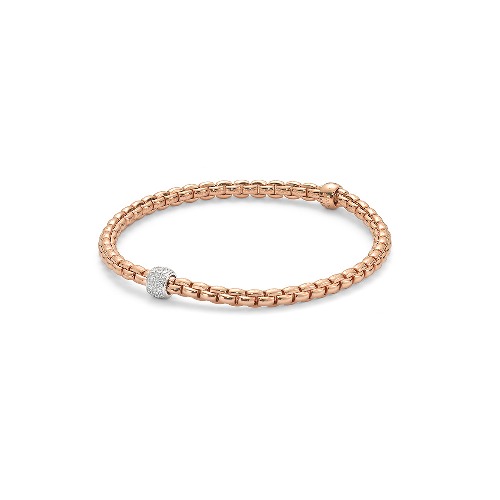 Eka – meaning ‘one’ in Sanskrit – is a whole new way of wearing gold bracelets. Based on one of Fope’s inventions from the 1950s, it applies the concept of flexibility to jewelry, blending together luxury and innovation. With its classic gold mesh design reworked in ultra-contemporary style, Flex’it has proved an instant global success. The effortless simplicity of every Fope bracelet ensures that you don't have to sacrifice your comfort for fashion. Classic yet fashion forward, this is most certainly not your grandmothers jewelry, each piece of FOPE gives an aura of intelligence and sophistication to those who wear it. Each bracelet has over 100 tiny 18k gold coils set into the interior of the link that allows the bracelet to expand and contract, rolling perfectly onto your wrist with ease. Handcrafted in Italy entirely from 18k gold and diamonds, this Eka Flex'it bracelet in size medium features one diamond rondel 0.19 cts of VS F/G Diamonds. FOPE Flex'It Bracelets are made in Five Sizes - Extra Small(15cm.), Small(16cm.), Medium(17cm), Large(18cm), and Extra Large(19cm). Standard size is considered medium and does fit most people. There are price differences between each size so please reach out to us for pricing information. Size/Color available for immediate shipment: 1. Size medium bracelet in white gold with a white gold diamond rondel 2. Size medium bracelet in rose gold with a white gold diamond rondel. All other sizes/colors will be ordered with a 4-6 week wait time. Eka Tiny Flex'it 18k Gold Bracelet - 733B PAVEM