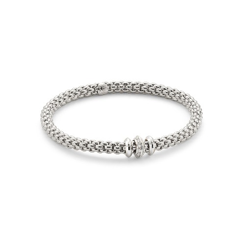 The Solo collection brings a new contemporary slant to Unica, the brand’s best-selling range in the Nineties. The bracelet’s gold mesh is now flexible, the proportions are slightly smaller than the thicker chains in vogue at the time, and there are numerous new versions with gold loops, pearls and diamonds in different carats. The matching set also includes chokers, chain and tassel necklaces, earrings and rings.
The effortless simplicity of every Fope Bracelet ensures that you don't have to sacrifice your comfort for fashion. Classic yet fashion forward, this is most certainly not your grandmothers jewelry, each piece of FOPE gives an aura of inteligence and sohistication to those who wear it.
Each bracelet has over 100 tiny 18k gold coils set into the interior of the link that allows the bracelet to expand and contract, rolling perfectly onto your wrist with ease. Handcrafted Entirely in Italy from 18k Gold and Diamonds, This Solo Flex'It Bracelet in size Medium features three rondels, two white gold rondels that flank one diamond encrusted rondel that sports two rows, 0.17cts, of VS F/G Diamonds.
FOPE Flex'It Bracelets are made in Five Sizes - Extra Small(15cm.), Small(16cm.), Medium(17cm), Large(18cm), and Extra Large(19cm). Standard size is considered Size Medium and fits most people. There are price differences between each size so please reach out to us for pricing information.
Size/Color Avaliable for Immediate Shippment is Size Medium in White Gold with White Gold and Diamond Rondels. All other sizes/colors will be ordered with a 4-6week lead time.
Flex'it White Gold Bracelet With Diamonds - 653B BBRM