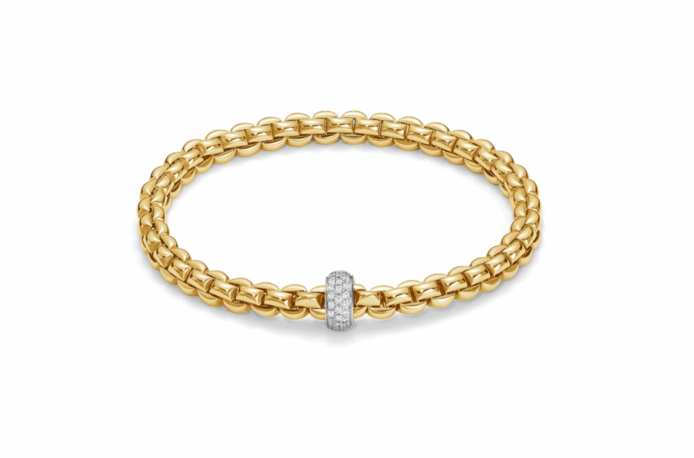 Eka – meaning ‘one’ in Sanskrit – is a whole new way of wearing gold bracelets. Based on one of Fope’s inventions from the 1950s, it applies the concept of flexibility to jewelry, blending together luxury and innovation. With its classic gold mesh design reworked in ultra-contemporary style, Flex’it has proved an instant global success. The effortless simplicity of every Fope bracelet ensures that you don't have to sacrifice your comfort for fashion. Classic yet fashion forward, this is most certainly not your grandmothers jewelry, each piece of FOPE gives an aura of intelligence and sophistication to those who wear it. Each bracelet has over 100 tiny 18k gold coils set into the interior of the link that allows the bracelet to expand and contract, rolling perfectly onto your wrist with ease. Handcrafted in Italy entirely from 18k gold and diamonds, this Eka Flex'it bracelet in size medium features one diamond rondel 0.37 cts of VS F/G Diamonds. FOPE Flex'It Bracelets are made in Five Sizes - Extra Small(15cm.), Small(16cm.), Medium(17cm), Large(18cm), and Extra Large(19cm). Standard size is considered medium and does fit most people. There are price differences between each size so please reach out to us for pricing information. Size/Color available for immediate shipment: Size medium bracelet in yellow gold with a white gold diamond rondel. All other sizes/colors will be ordered with a 4-6 week wait time. Flex'It Eka Pave Rondel