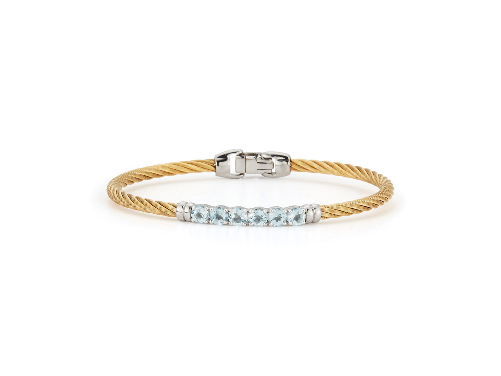 Bring a bit of shine and light into the life of your loved one with this ALOR Ladies Bangle.
Complete with yellow gold, twisted cable bands, a white gold surrounded selection of blue topaz jewels, and a stainless steel clasp, this bangle could not be more beautiful.
The ideal gift for those born in November, this bangle will also make a great anniversary, holiday, or wedding gift.
Available in several sizes to fit almost any wearer. Order yours today.
Yellow cable, 14 karat White Gold, 1.72 total carat weight Blue Topaz and stainless steel. Imported. ALOR Ladies Bangle – Yellow Cable with White Gold and Blue Topaz Gemstones